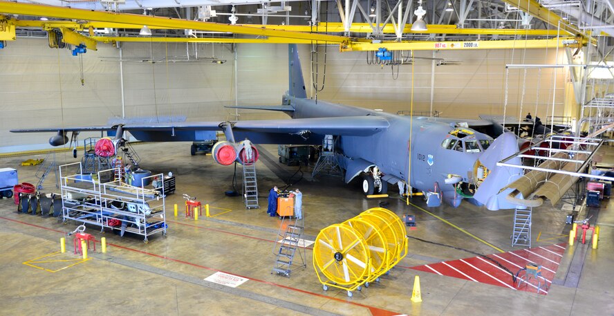 Airmen with the 2nd Maintenance Squadron phase hangar perform a periodic inspection on a B-52H Stratofortress on Barksdale Air Force Base, La., Nov. 24, 2014. A periodic inspection is performed on all aircraft with more than 450 flight hours. Access panels are removed and inspected by engineers. Each inspection is a 14-day phase starting with panel removal and 11 maintenance flights inspect each component of the aircraft looking for defects. Once finalized, phase Airmen completely reassemble the aircraft. (U.S. Air Force photo/Airman 1st Class Mozer O. Da Cunha).