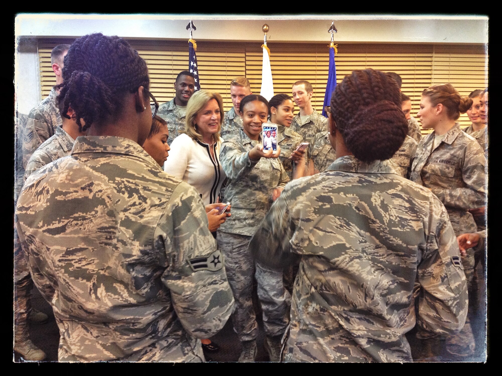 Secretary of the Air Force Deborah Lee James takes selfies with Airmen at the Ginko Tree Dining Facility Nov. 24, 2014, at Osan Air Base, Republic of Korea. James met and talked with Airmen on her trip to Osan as part of her 11-day visit to the Pacific region. (U.S. Air Force photo by Staff Sgt. Jake Barreiro)