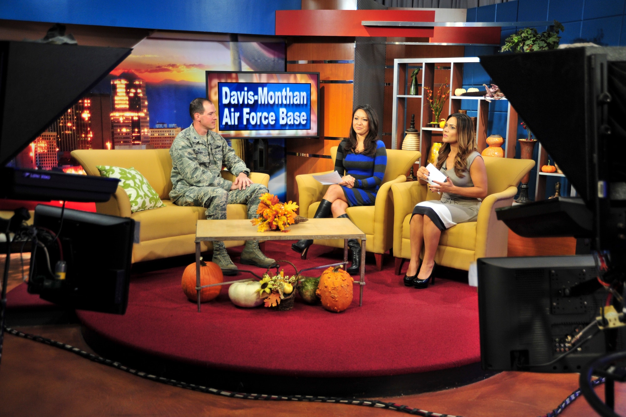 U.S. Air Force Col. James P. Meger, 355th Fighter Wing commander, Davis-Monthan Air Force Base, Ariz., talks about D-M current events with local TV hosts, Tina Jennings and Maria Parmigiani, during a live recording of "The Morning Blend" show at KGUN9 Studio, Tucson, Ariz., Nov. 24, 2014.  Meger discussed his vision for D-M as well as the Total Force Training Environmental Assessment public comment timeline.  (U.S. Air Force Photo by Airman 1st Class Chris Massey/Released)