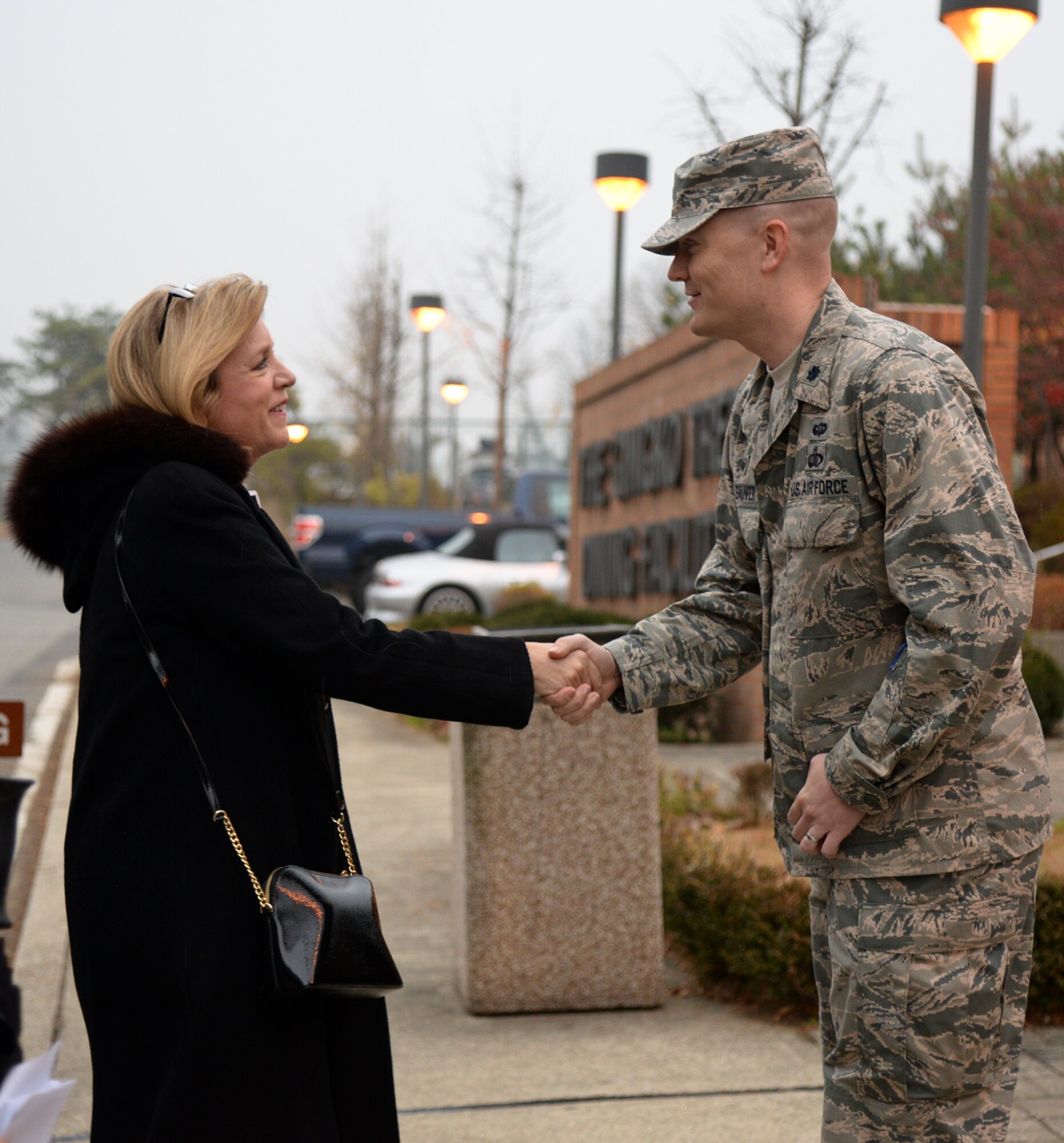 Secretary of the Air Force Deborah Lee James greets Lt. Col. Charles St. Stauver, 51st Force Support Squadron commander, outside the Ginko Tree Dining Facility Nov. 24, 2014, at Osan Air Base, Republic of Korea. James visited Osan Air Base as part of an 11-day trip to the Pacific region. During her visit she received a brief on the 51st FW’s mission and talked with base Airmen at an all call. (U.S. Air Force photo by Staff Sgt. Jake Barreiro)