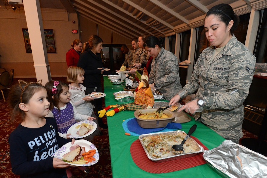 Airman 1st Class Alyssa Lucero, 66th Medical Squadron Mental Health technician, serves families alongside other volunteers during a Thanksgiving-themed Hearts Apart meeting at the Minuteman Commons Nov. 19. Hearts Apart meets monthly to provide support and other services to families of service members who are either deployed or are temporarily stationed at other locations. (U.S. Air Force photo by Jerry Saslav)