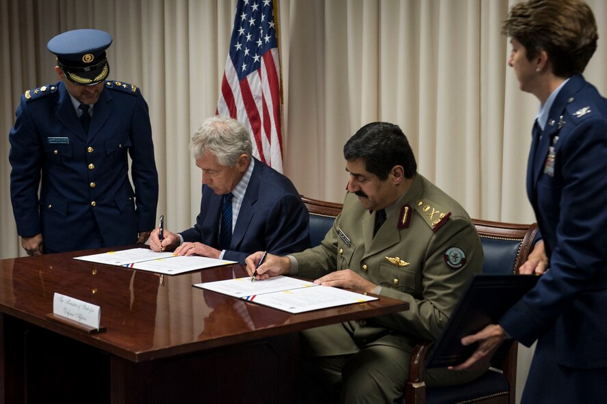U.S. Defense Secretary Chuck Hagel and Hamad bin Ali al Attiyah, Qatari minister of state for defense affairs, sign letters of offer and acceptance for Apache helicopters and Patriot and Javelin defense systems at the Pentagon, July 14, 2014. Hanscom AFB, Mass., will be assisting Qatar with the creation of an Integrated Air and Missile Defense System.(Photo by U.S. Navy Petty Officer 2nd Class Sean Hurt) 
