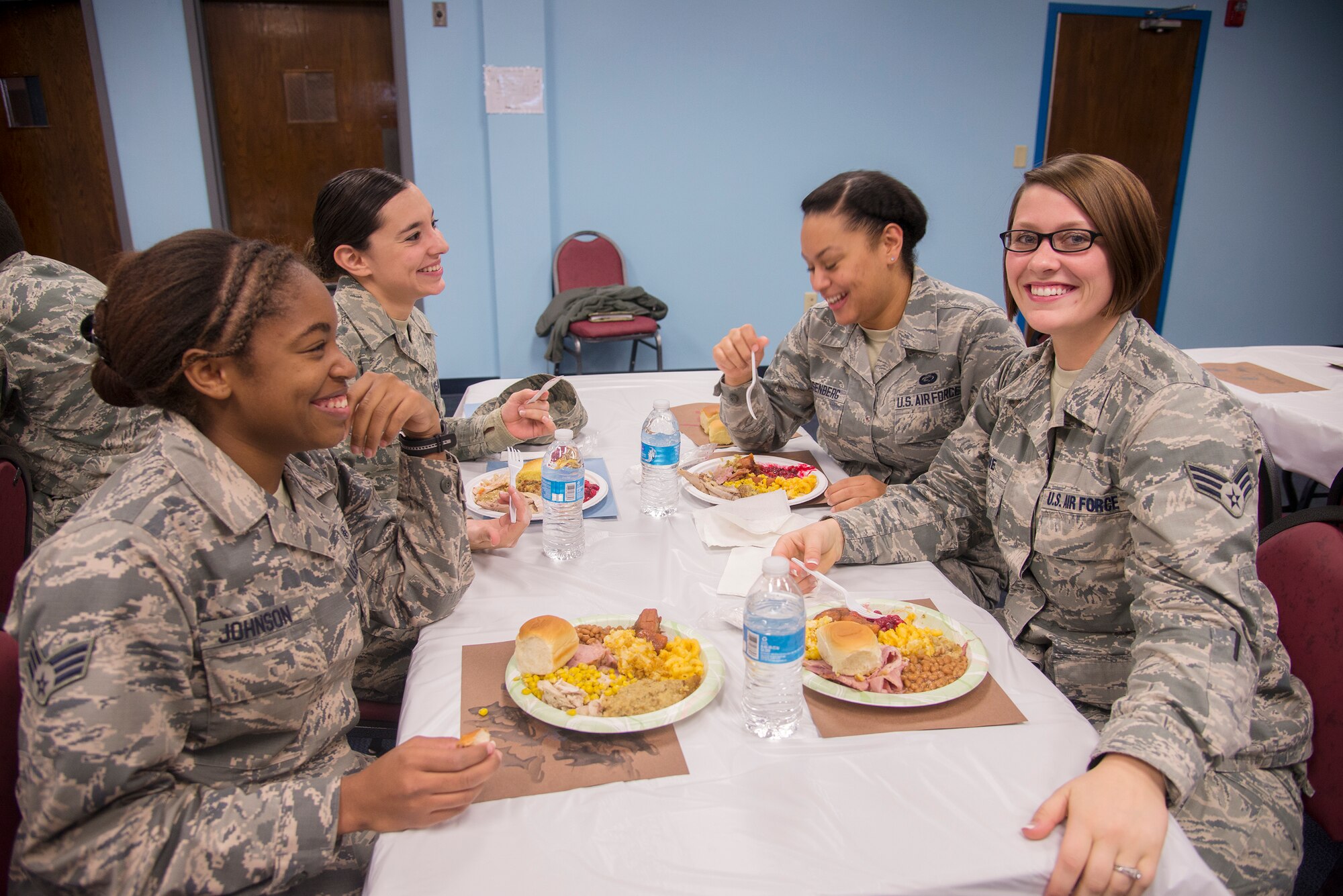 Airmen from the 23d Medical Group sit together for a traditional Thanksgiving meal Nov. 20, 2014, at Moody Air Force Base, Ga. Approximately ten base leaders volunteered to serve the food donated by Team Moody members. (U.S. Air Force photo by Senior Airman Sandra Marrero/Released)
