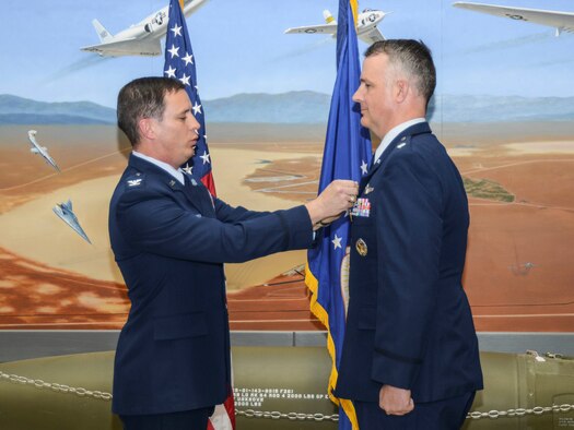 Lt. Col. Michael Morgan receives his retirement pin from NASA Astronaut Col. Jack Fisher Nov. 21 at the Air Force Flight Test Museum. (U.S. Air Force photo by Rebecca Amber)