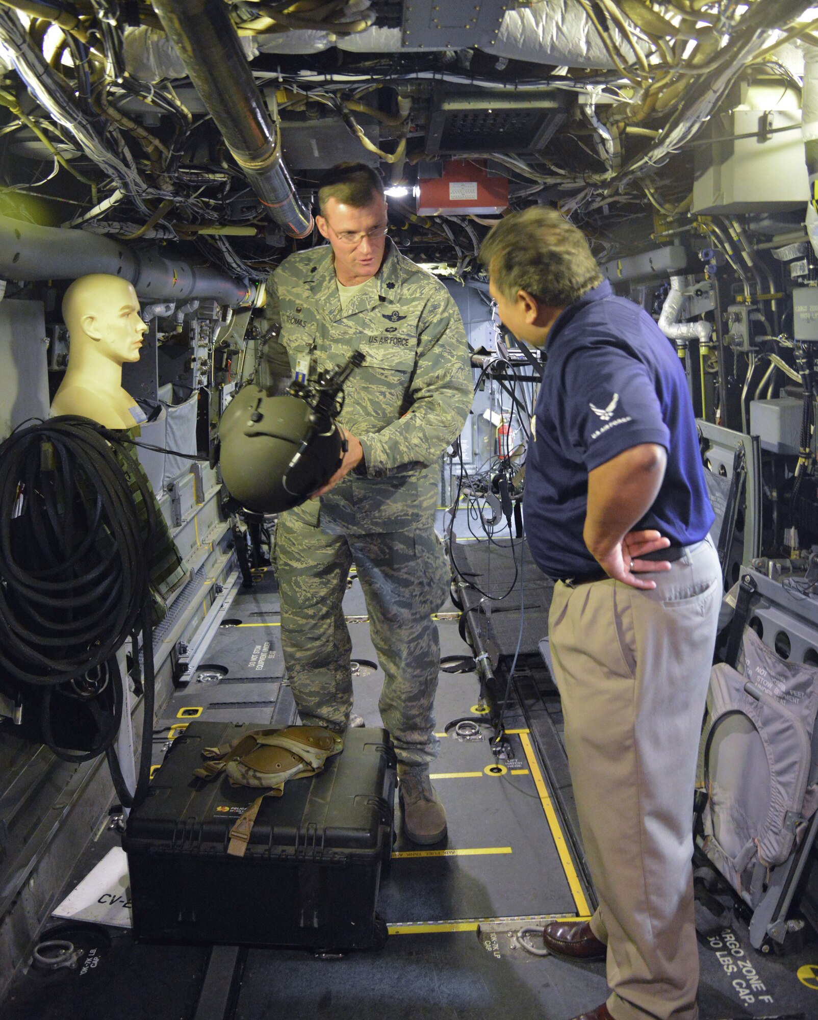 Lt. Col. Michael Thomas, left, and Gilbert Montoya of the Air Education and Training Command headquarters talk about how virtual reality is combined with a physical training environment. (Photo by Ken Moore)