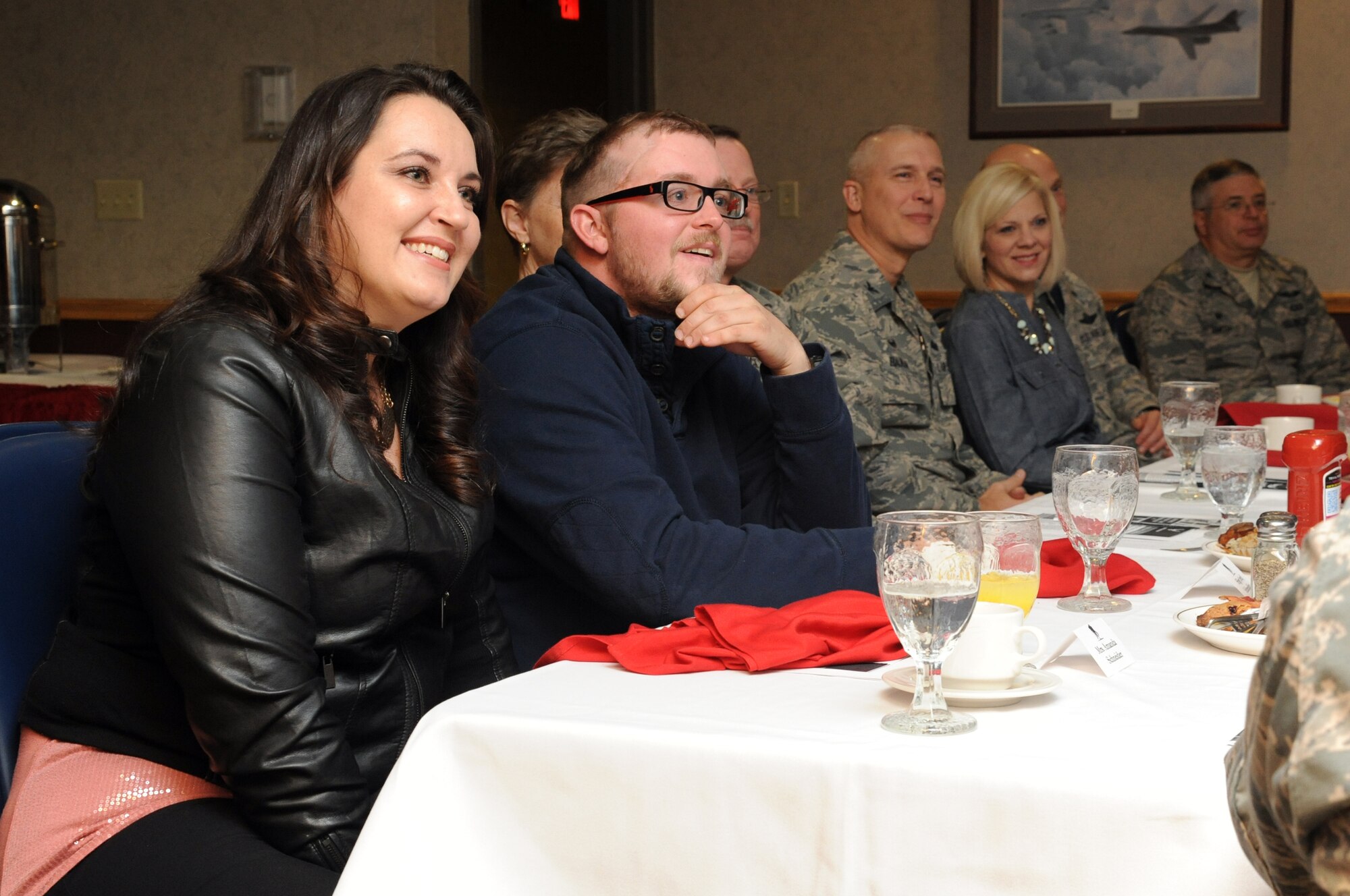 Staff Sgt. (ret.) Kristopher Schneider (with glasses) and his wife Amanda listen to questions from Airmen at the Warrior Care Month breakfast in the Northern Lights Club on Grand Forks Air Force Base, N.D., Nov. 21, 2014. The Schneiders came to speak about the care and attention their family received following Sergeant Schneider's involvement with the Frankfurt Airport terrorist shootings of 2011. (U.S. Air Force photo/Staff Sgt. David Dobrydney)