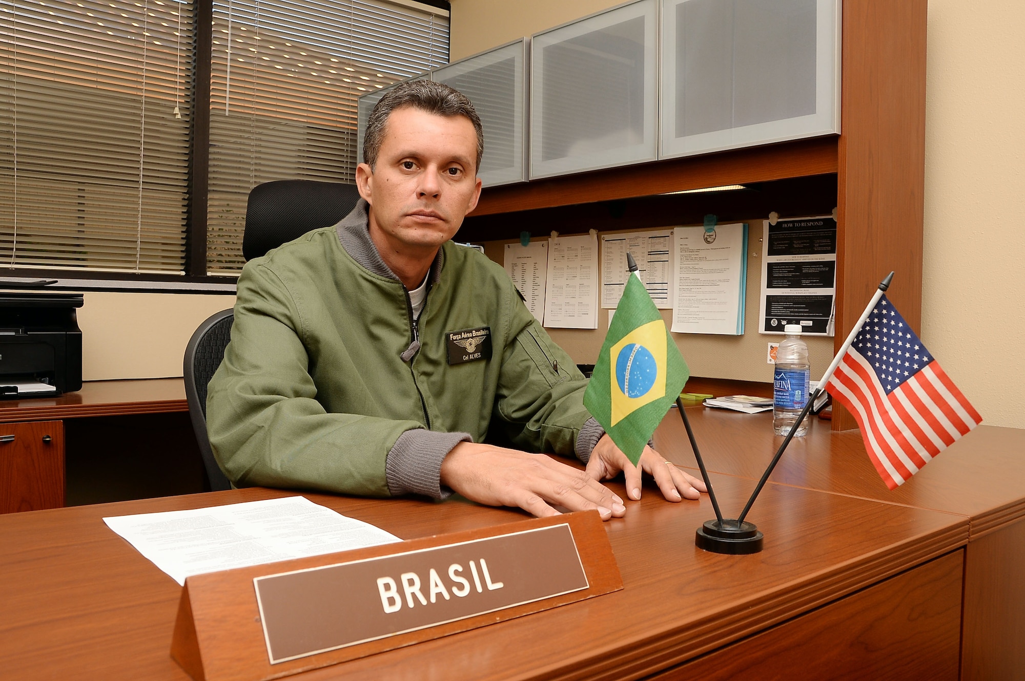 Colonel Alexandre Alves, Air Forces Southern Brazilian Liaison Officer, prepares to execute his daily duties as LNO at Davis-Monthan AFB, Ariz., Nov. 24, 2014. Alves has been serving in the Brazilian air force since 1985, and serves as the sole liaison on all endeavors dealing with Brazil for AFSOUTH. (U.S. Air Force photo by Staff Sgt. Adam Grant/Released)