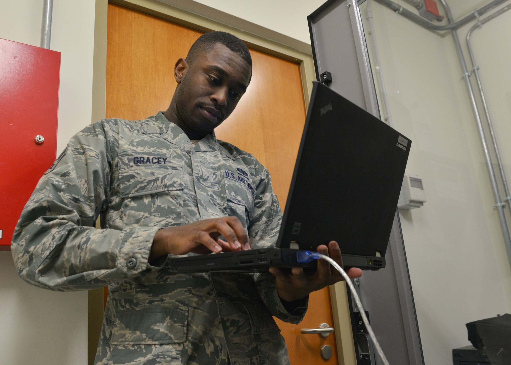 Airman 1st Class Peter Gracey, 31st Communications Squadron cyber transport systems journeyman, checks the connectivity of a communication switch board, Nov. 24, 2014, at Aviano Air Base, Italy. Cyber transport systems specialists ensure the core infrastructure of the Air Force’s network is properly working to maintain global communication. (U.S. Air Force photo/Airman 1st Class Deana Heitzman)