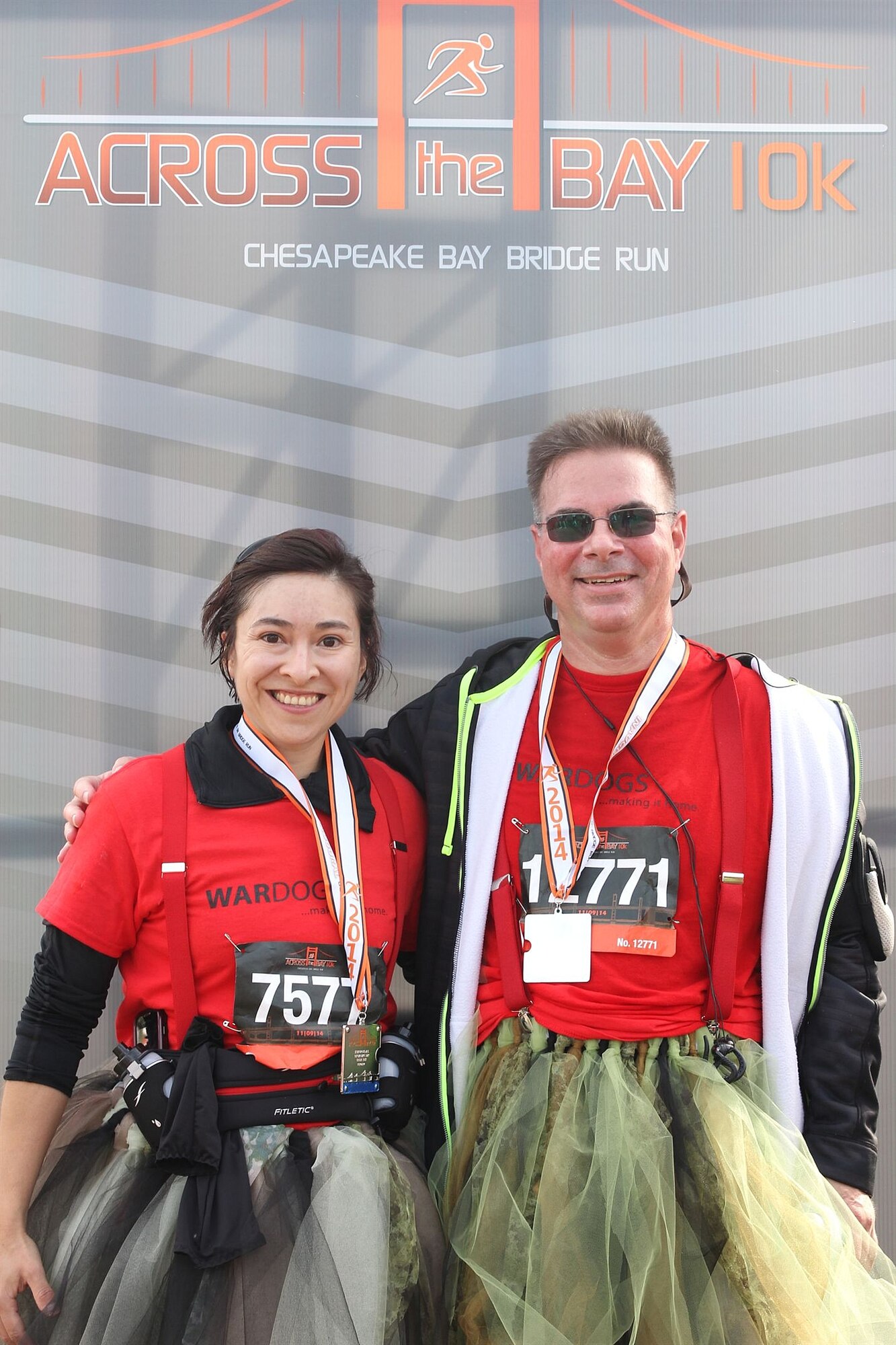 Tech. Sgt. Carolina Rodriquez and Master Sgt. Ron Broccolino, loadmasters with the 709th Airlift Squadron, stop for a picture with their tutus on after the race "Across the Bay 10K" this Nov. Rodriquez and Broccolino bet their group of friends and family that they would wear tutus while running if their team could raise $2,000 before the race, which they did. 