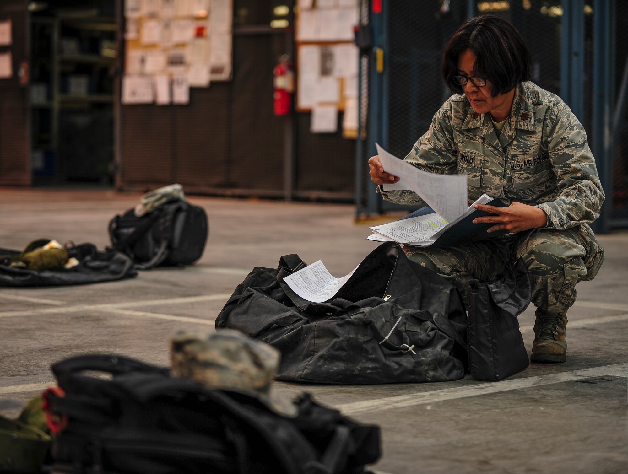 Maj. Judy Tupolo, 39th Medical Group education and training officer, reads through a checklist of items issued to her during an individual protection equipment issue at the 39th Logistics Readiness Squadron Nov. 21, 2014, at Incirlik Air Base, Turkey. The 39th LRS is responsible for more than $351 million in equipment and supplies. (U.S. Air Force photo by Airman Cory W. Bush/Released)