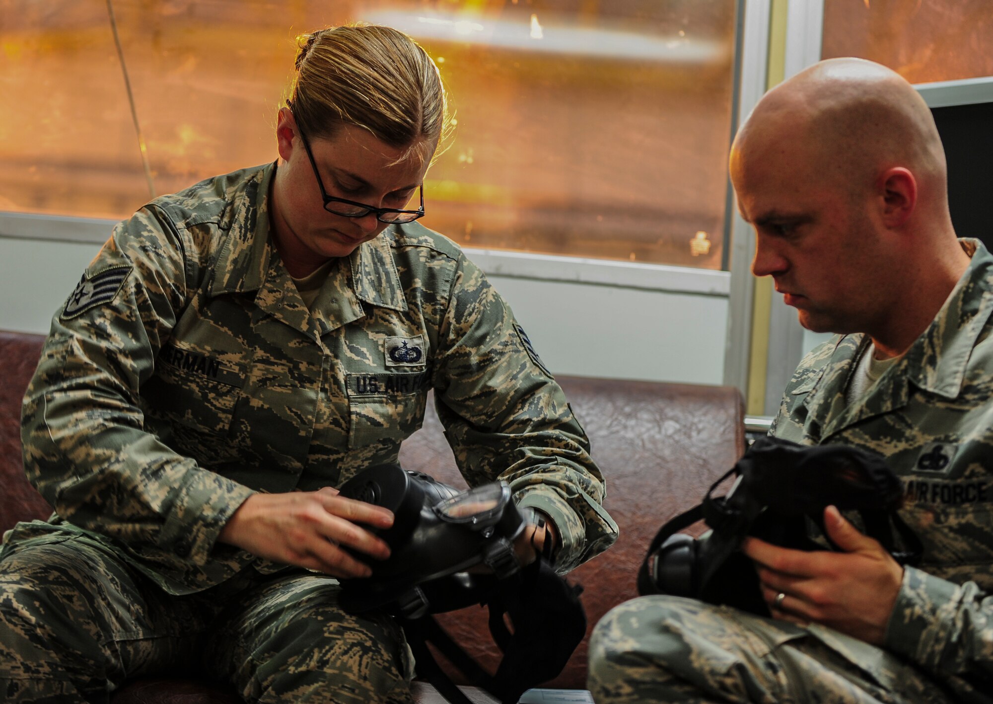 Staff Sgt. Ann Marie Bierman, 39th Contracting Squadron contract specialist, adjust the straps of her gas mask during a gas mask fit test Nov. 21, 2014, at Incirlik Air Base, Turkey. The LRS has a hand in every facet of base and mission operations as the organization responsible for executing war readiness, transportation, supply and fuels support. (U.S. Air Force photo by Airman Cory W. Bush/Released)