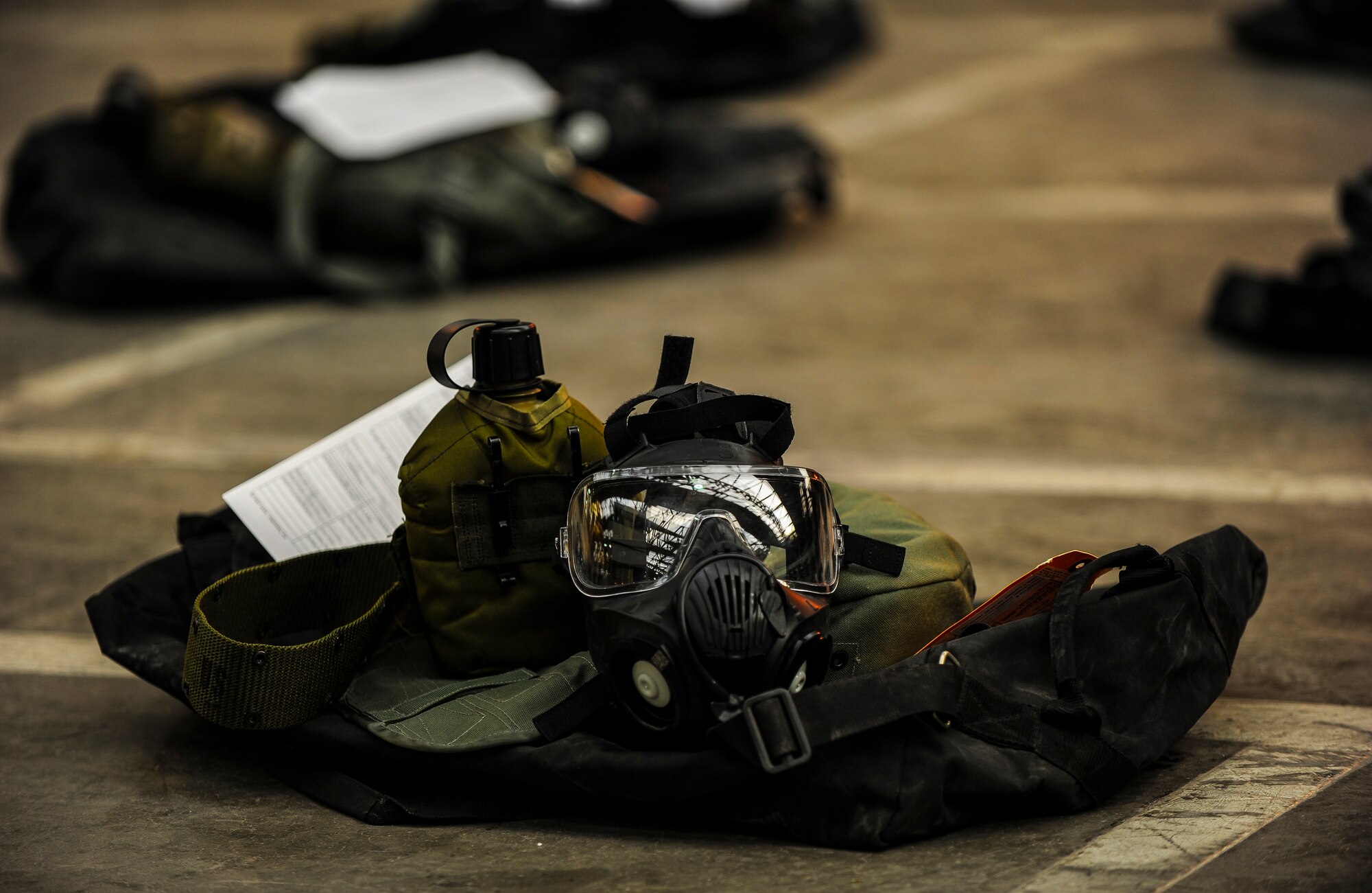 The 39th Logistics Readiness Squadron issues Airmen individual protection equipment Nov. 21, 2014, at Incirlik Air Base, Turkey. The storage bag consists of a canteen with cover, web belt and a gas mask with a carrier case. (U.S. Air Force photo by Airman Cory W. Bush/Released)