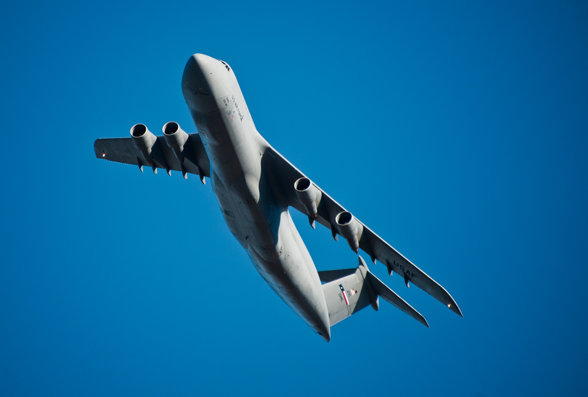 A 433rd Airlift Wing C-5 Galaxy begins to turn over the Eglin Air Force Base, Fla., runway before landing.  The reserve aircrew of the “heavy” aircraft brought Army 7th Special Forces Group personnel and equipment to the base for delivery.  (U.S. Air Force photo/Samuel King Jr.)