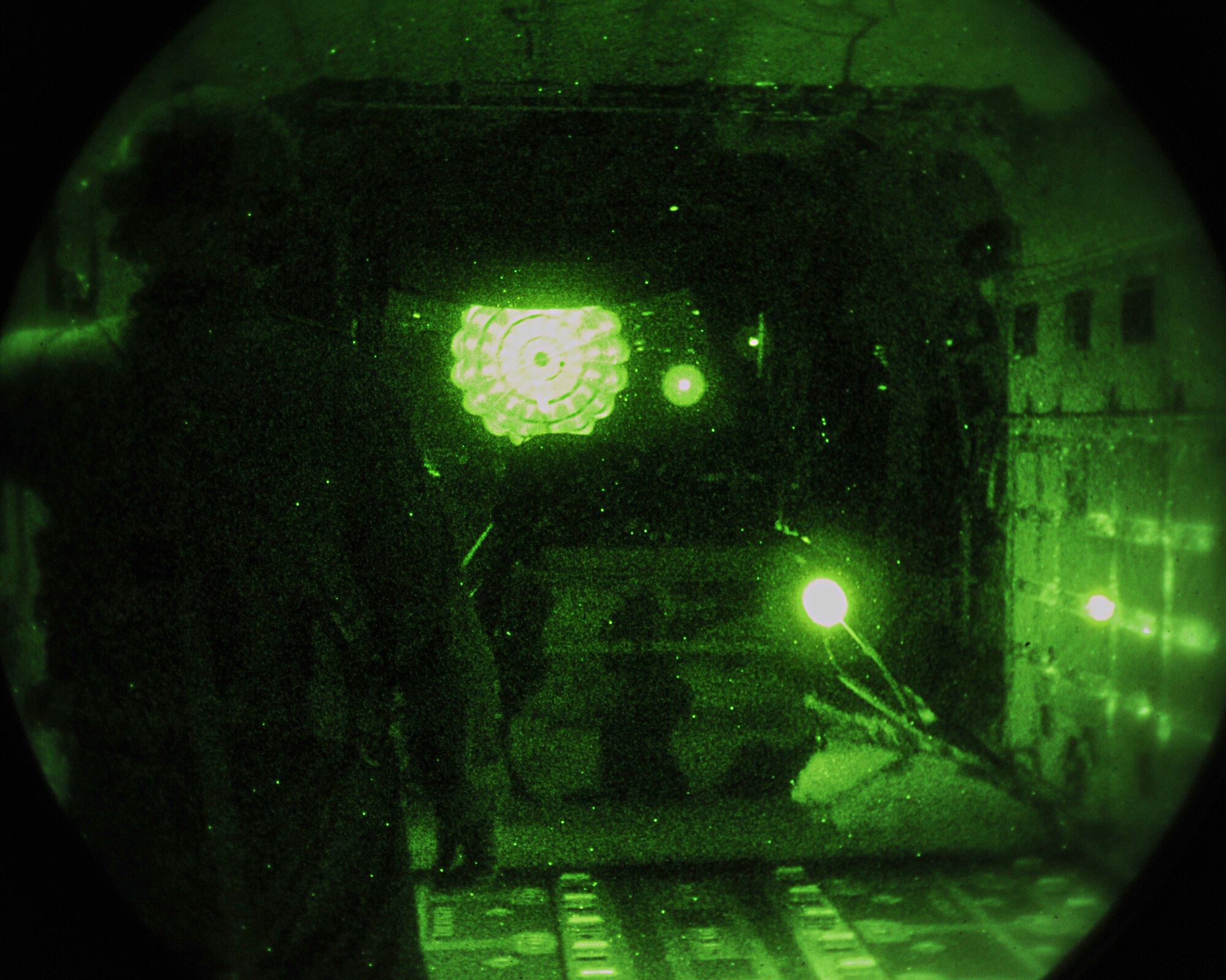 U.S. Air Force Tech. Sgt. Mike Weller, 67th Special Operations Squadron loadmaster from Mallard, Iowa, watches as cargo is released from an MC-130J Commando II during a training mission Nov. 17, 2014, off the eastern coast of England. During the mission, the aircrew accomplished three airdrops and refueled two CV-22B Ospreys. (U.S. Air Force photo by Airman 1st Class Preston Webb/Released)