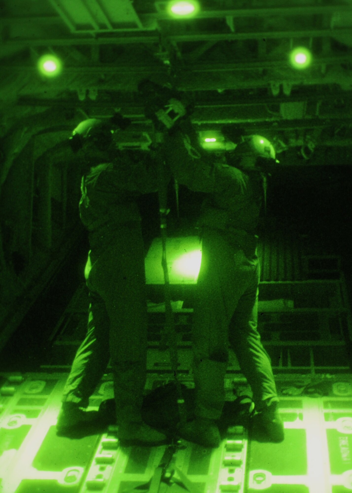 U.S Air Force Master Sgt. Mario McBride, right, 67th Special Operations Squadron loadmaster from Fort Walton Beach, Fla., and U.S. Air Force Tech. Sgt. Mike Weller, 67th SOS loadmaster from Mallard, Iowa, prepare a high-velocity parachute to pull cargo out of an MC-130J Commando II Nov. 17, 2014, off the eastern coast of England. G-12E, T10 and high-velocity variant parachutes were used to make three airdrops during a training mission. (U.S. Air Force photo by Airman 1st Class Preston Webb/Released)