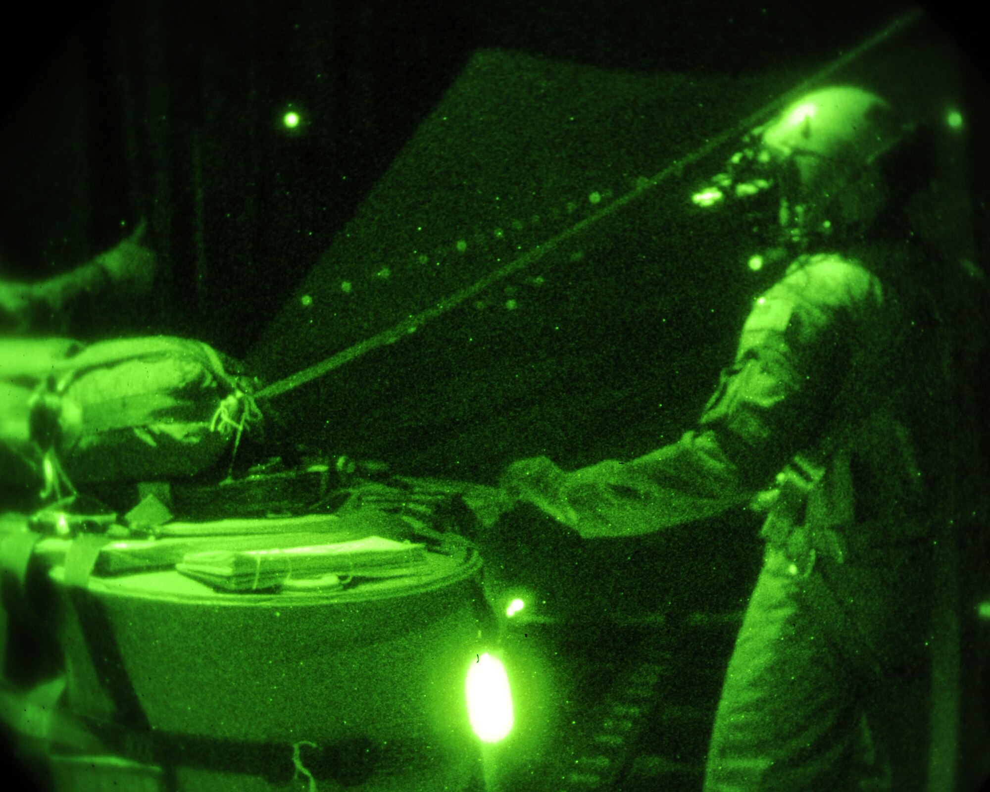 U.S Air Force Master Sgt. Mario McBride, 67th Special Operations Squadron loadmaster from Fort Walton Beach, Fla., prepares cargo for airdrop Nov. 17, 2014, over the eastern coast of England. The training mission provided the aircrew the opportunity to stay current on use of three types of parachutes, air refueling techniques and multiple tactical maneuvers. (U.S. Air Force photo by Airman 1st Class Preston Webb/Released)