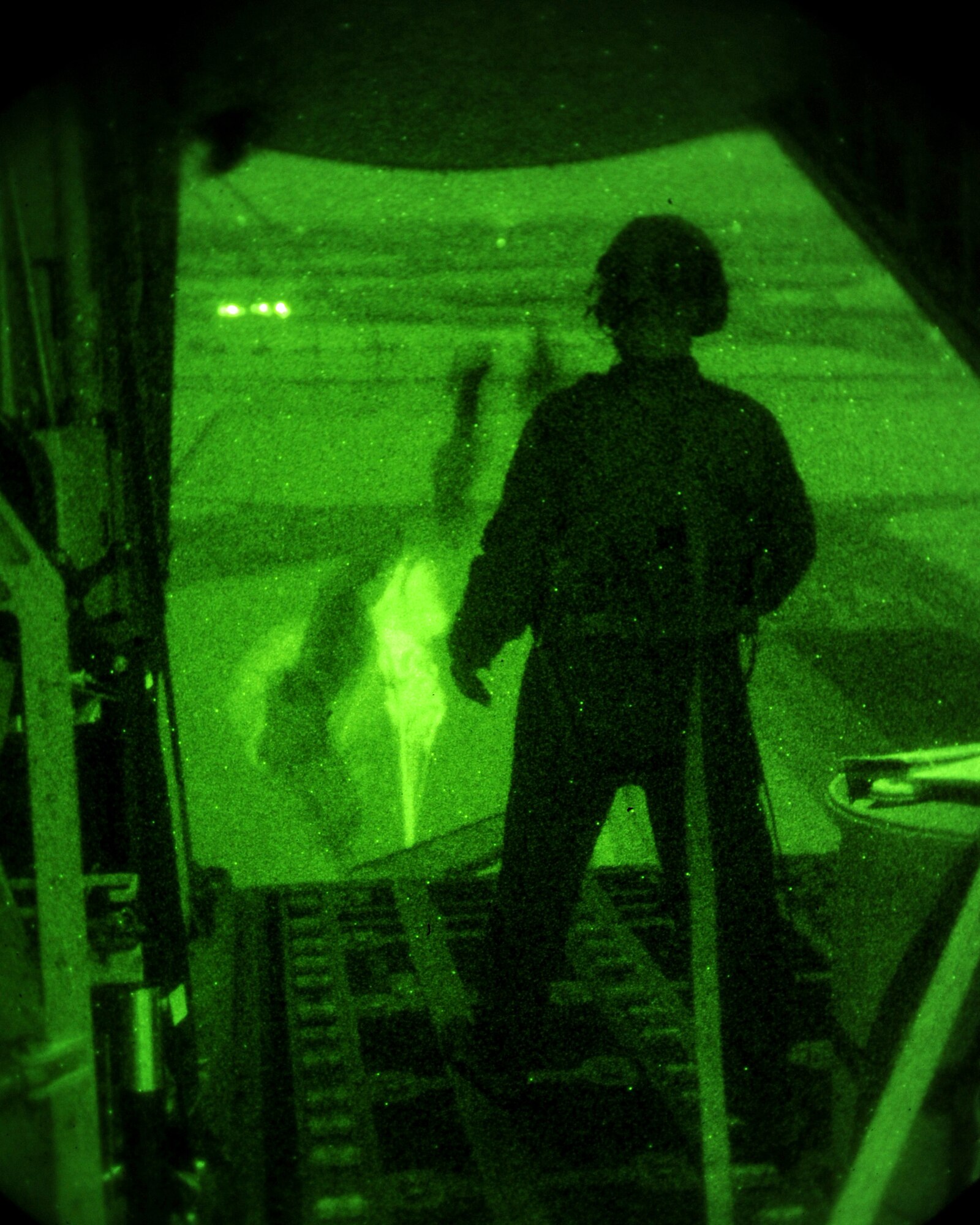 U.S. Air Force Tech. Sgt. Mike Weller, 67th Special Operations Squadron loadmaster from Mallard, Iowa, watches as cargo is released from an MC-130J Commando II during a training mission Nov. 17, 2014, over the eastern coast of England. During the mission, the aircrew accomplished three airdrops using multiple types of parachutes to maximize their effectiveness. (U.S. Air Force photo by Airman 1st Class Preston Webb/Released)