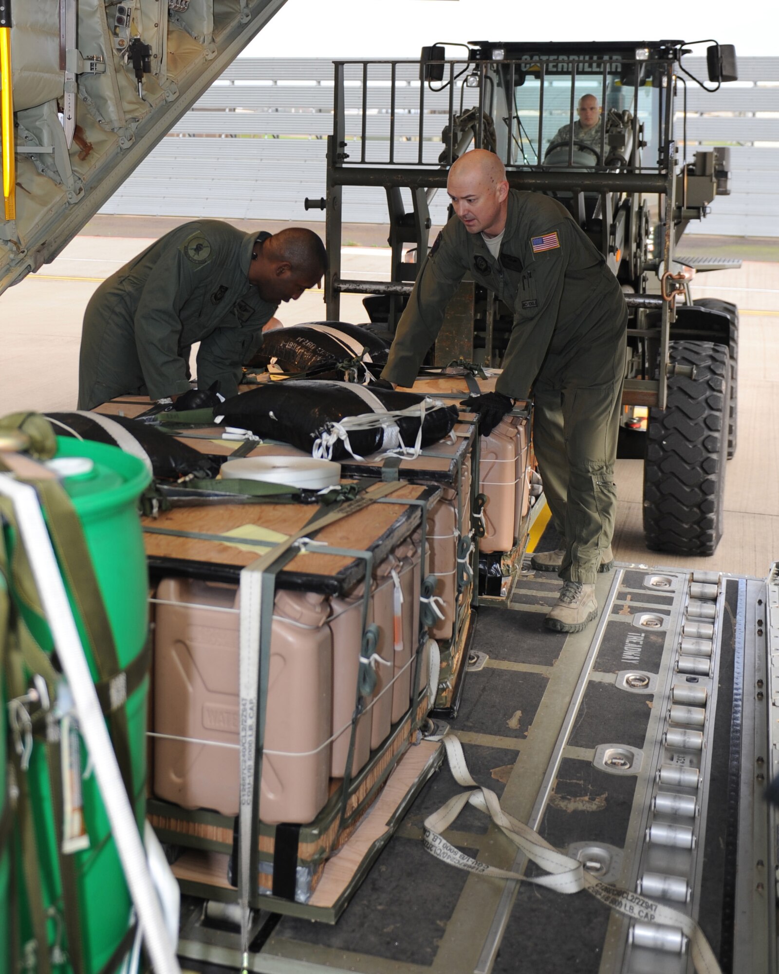 U.S Air Force Master Sgt. Mario McBride, left, 67th Special Operations Squadron loadmaster from Fort Walton Beach, Fla., and U.S. Air Force Tech. Sgt. Mike Weller, 67th SOS loadmaster from Mallard, Iowa,  prepare cargo for flight Nov. 17, 2014, at RAF Mildenhall, England. The mission allowed Air Commandos to accomplish training on several tactical maneuvers, three airdrops and air refueling of two CV-22B Ospreys. (U.S. Air Force photo by Airman 1st Class Preston Webb/Released)