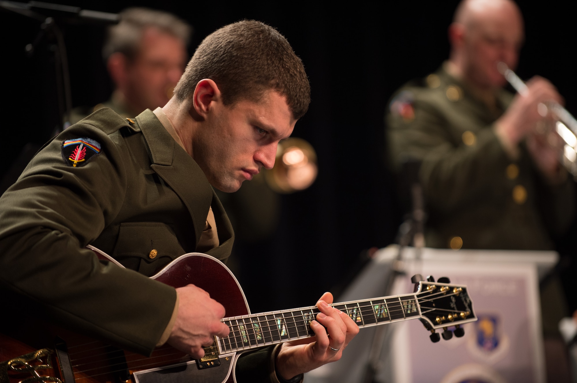 Staff Sgt. Dustin Trimble, regional guitarist for the U.S. Air Forces in Europe Band, plays a song during a Battle of the Bulge 70th anniversary commemoration event, Nov. 22, 2014, in Bastogne, Belgium. The USAFE Band played throughout Europe since September stopping at villages that were affected by the battle. The band featured approximately 20 songs from the 1940s, bringing joy and nostalgia to the audience. (U.S. Air Force photo/Senior Airman Jonathan Stefanko)