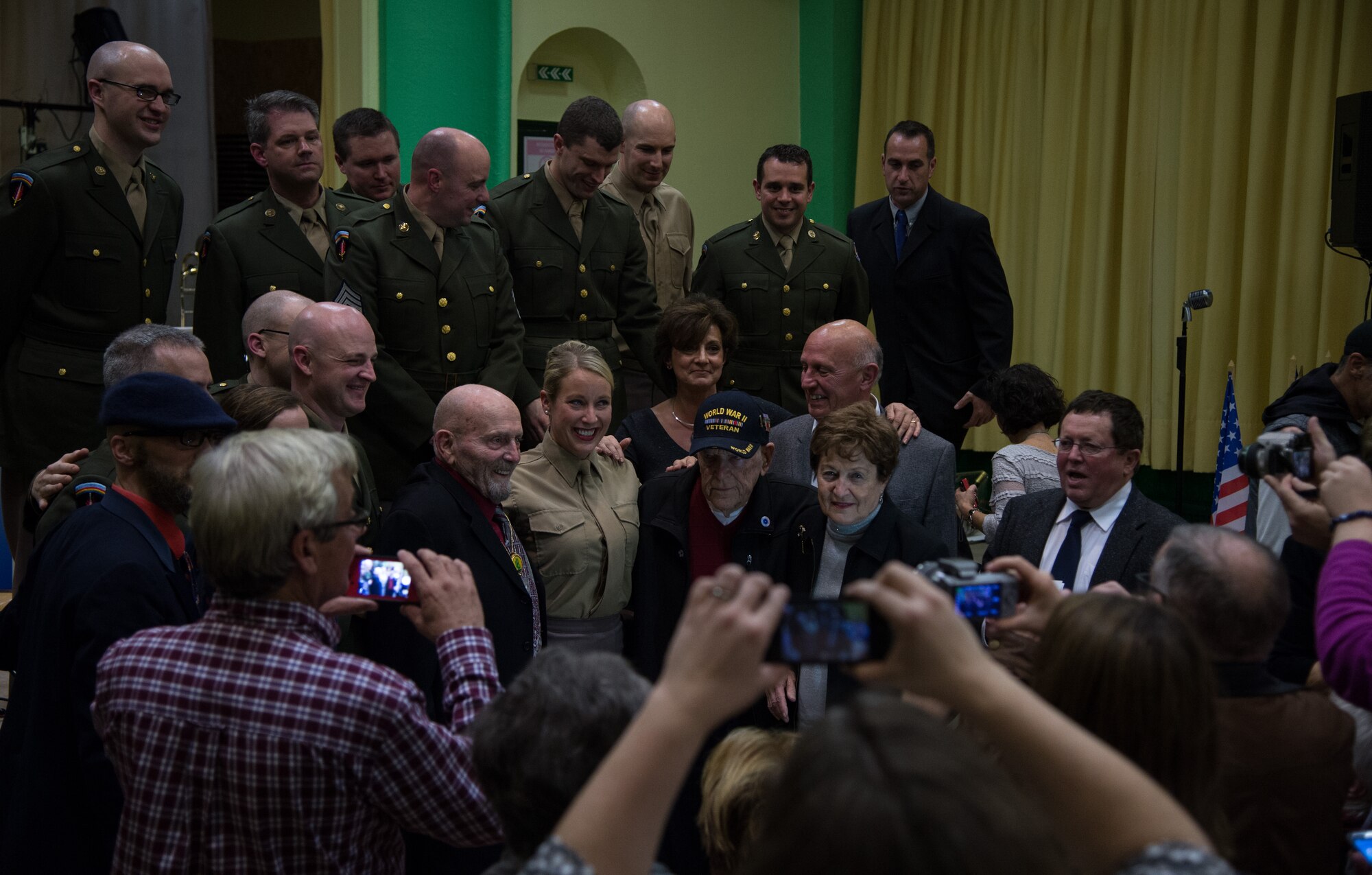 The U.S. Air Forces in Europe Band gather with American military veterans who fought during a Battle of the Bulge 70th anniversary commemoration event, Nov. 23, 2014, in Saulcy-sur Meurthe, France. The USAFE Band played throughout Europe since September stopping at villages that were affected by the battle. The band featured approximately 20 songs from the 1940s, bringing joy and nostalgia to the audience. (U.S. Air Force photo/Senior Airman Jonathan Stefanko)