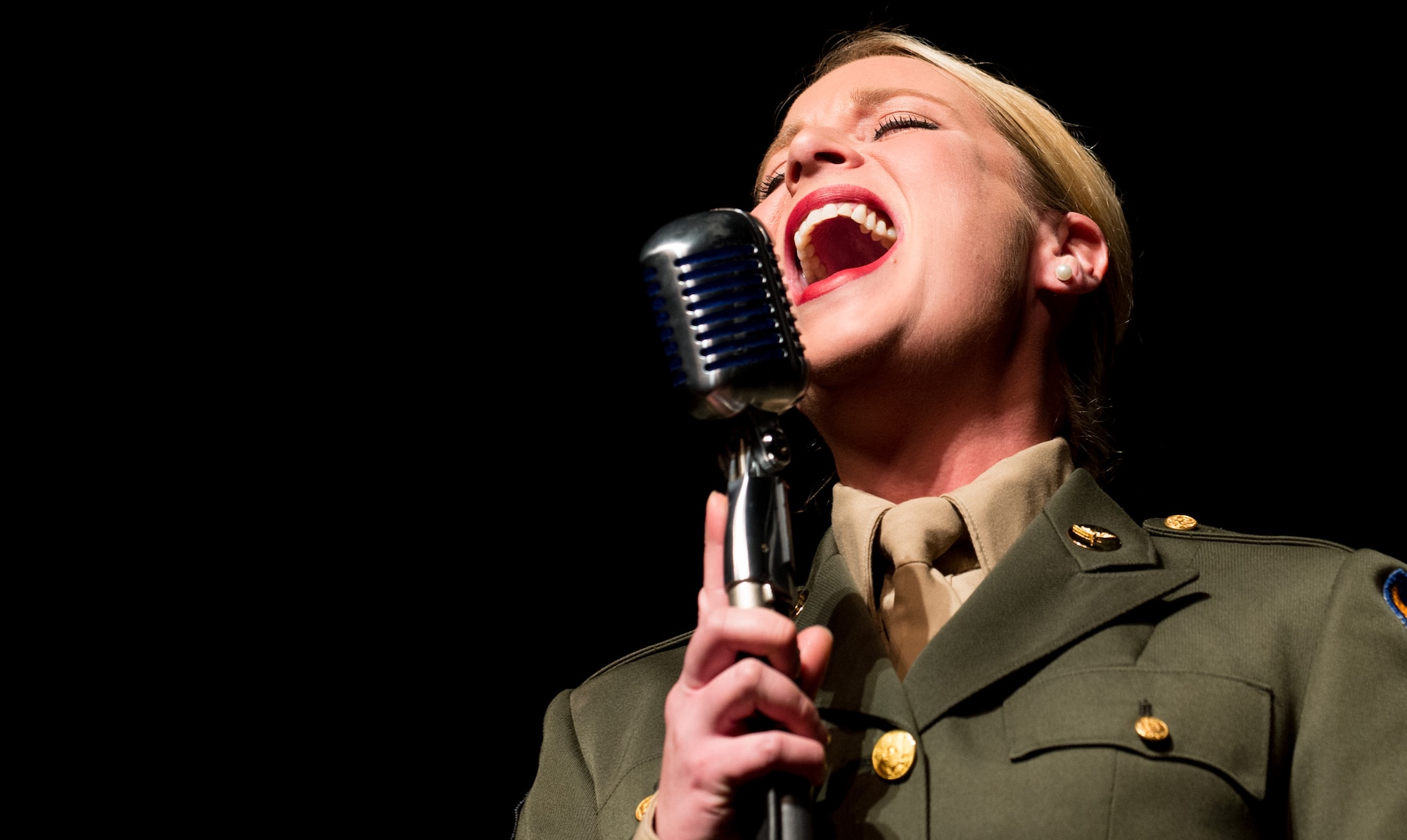Staff Sgt. Jill Diem, regional vocalist for the U.S. Air Forces in Europe Band, sings during a Battle of the Bulge 70th anniversary commemoration event, Nov. 22, 2014, in Bastogne, Belgium. The USAFE Band played throughout Europe since September stopping at villages that were affected by the battle. The band featured approximately 20 songs from the 1940s, bringing joy and nostalgia to the audience. (U.S. Air Force photo/Senior Airman Jonathan Stefanko)