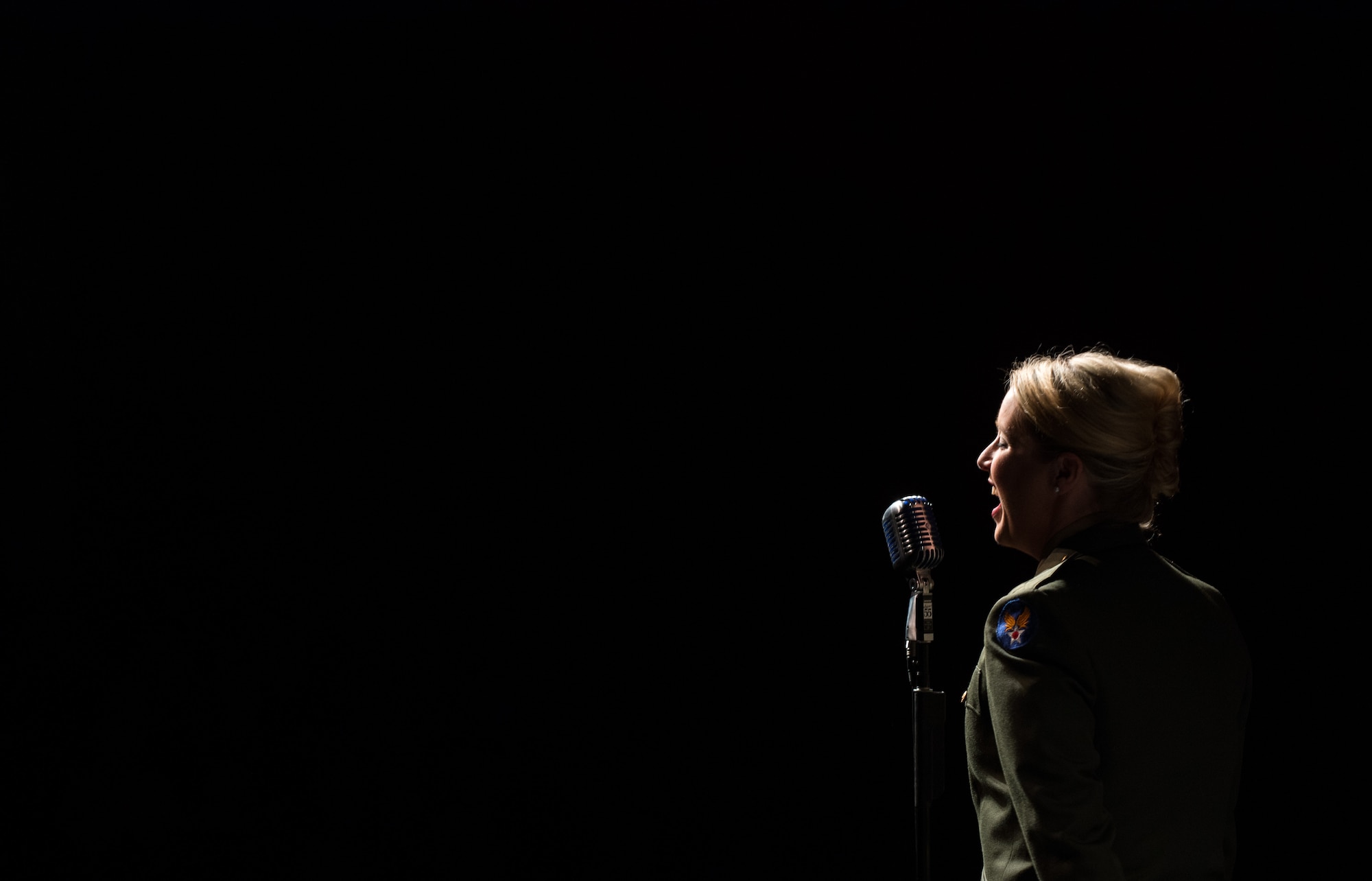 Staff Sgt. Jill Diem, regional vocalist for the U.S. Air Forces in Europe Band, sings during a Battle of the Bulge 70th anniversary commemoration event, Nov. 22, 2014, in Bastogne, Belgium. The USAFE Band played throughout Europe since September stopping at villages that were affected by the battle. The band featured approximately 20 songs from the 1940s, bringing joy and nostalgia to the audience. (U.S. Air Force photo/Senior Airman Jonathan Stefanko)