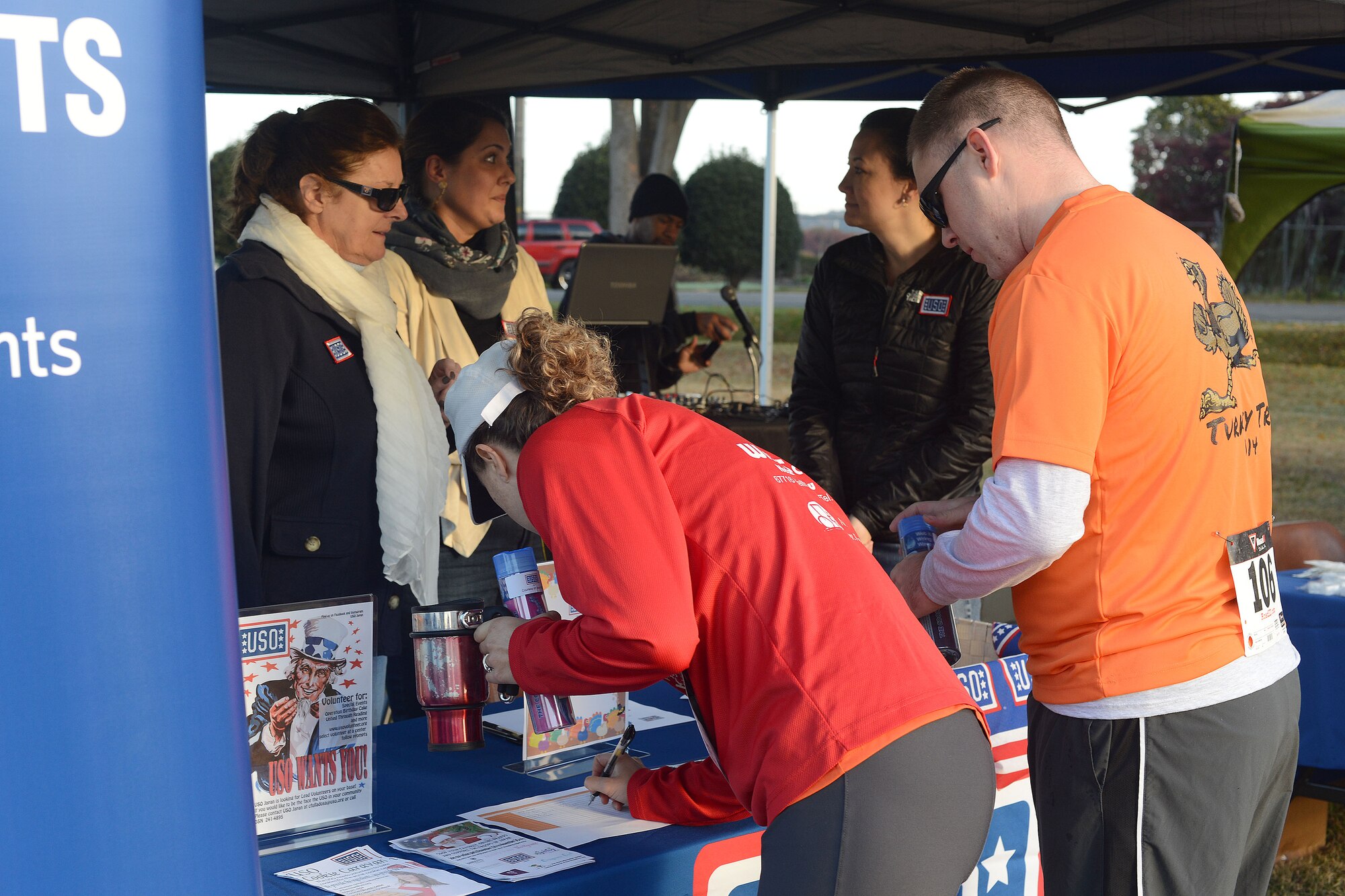 Participants sign up to receive fitness towels from the USO at the Turkey Trot 5k Fun Run at Yokota Air Base, Japan, Nov. 21, 2014.  Booths were set up to provide information to runners about upcoming USO events and the Great American Smokeout event. (U.S. Air Force photo by Tech. Sgt. Melissa K. Mekpongsatorn/Released)
