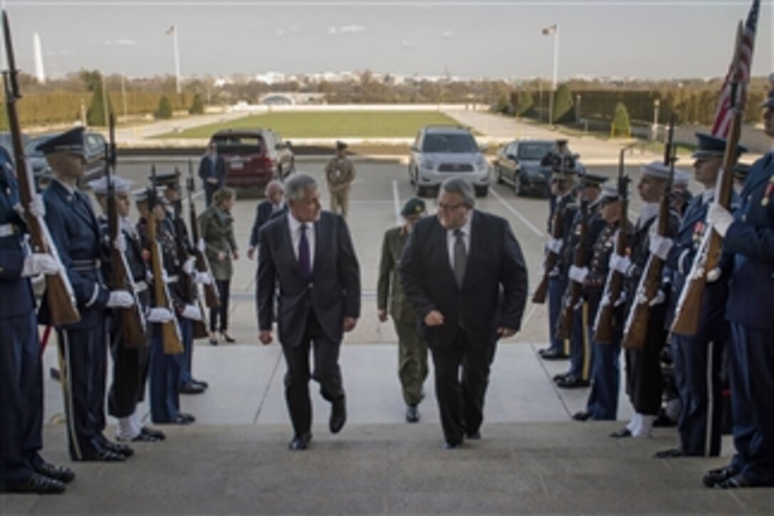 U.S. Defense Secretary Chuck Hagel, left, and New Zealand Defense Minister Gerry Brownlee pass through an honor cordon at the Pentagon, Nov. 24, 2014. The leaders met to discuss matters of mutual importance.