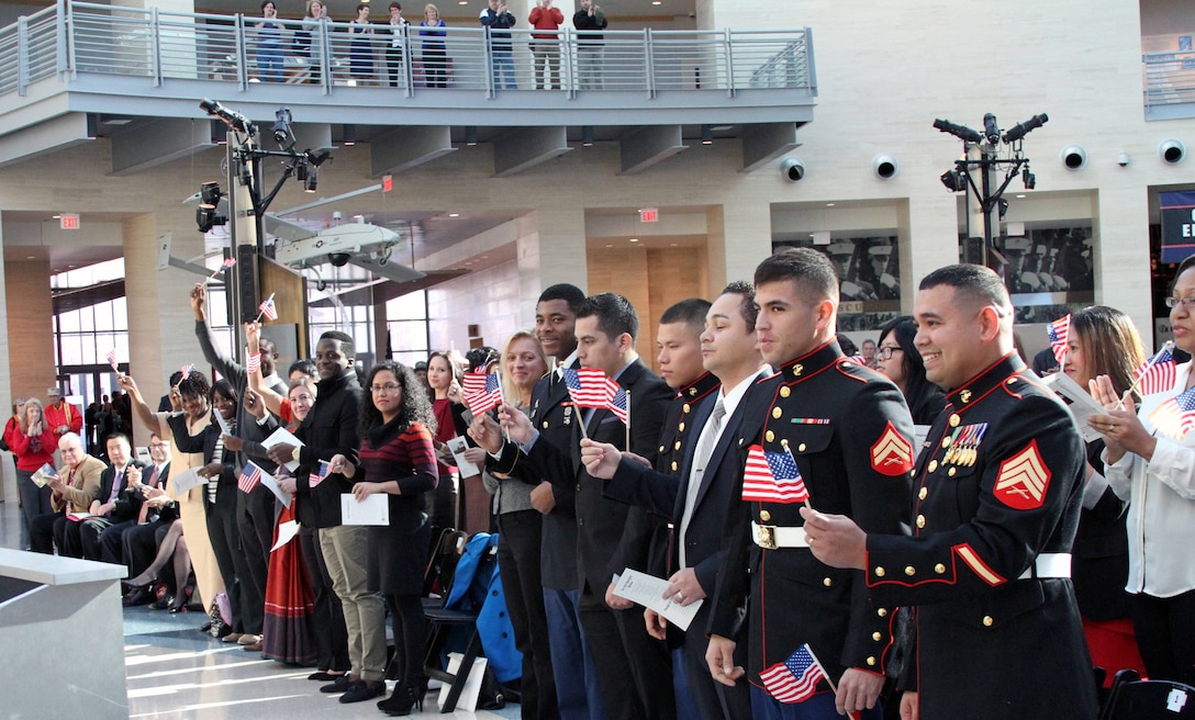 U.S. Marine Corps Sgt. Gustavo A. Arroliga, a recruiter with Recruiting Sub-Station Woodbridge and native of Nicaragua, waits for the Oath of Allegiance during a naturalization Ceremony held at the National Museum of the Marine Corps Nov. 10, 2014. His naturalization allows him to apply for a security clearance that is required for his job as a recruiter. (U.S. Marine Corps photo by. Cpl. Amber Williams/Released)