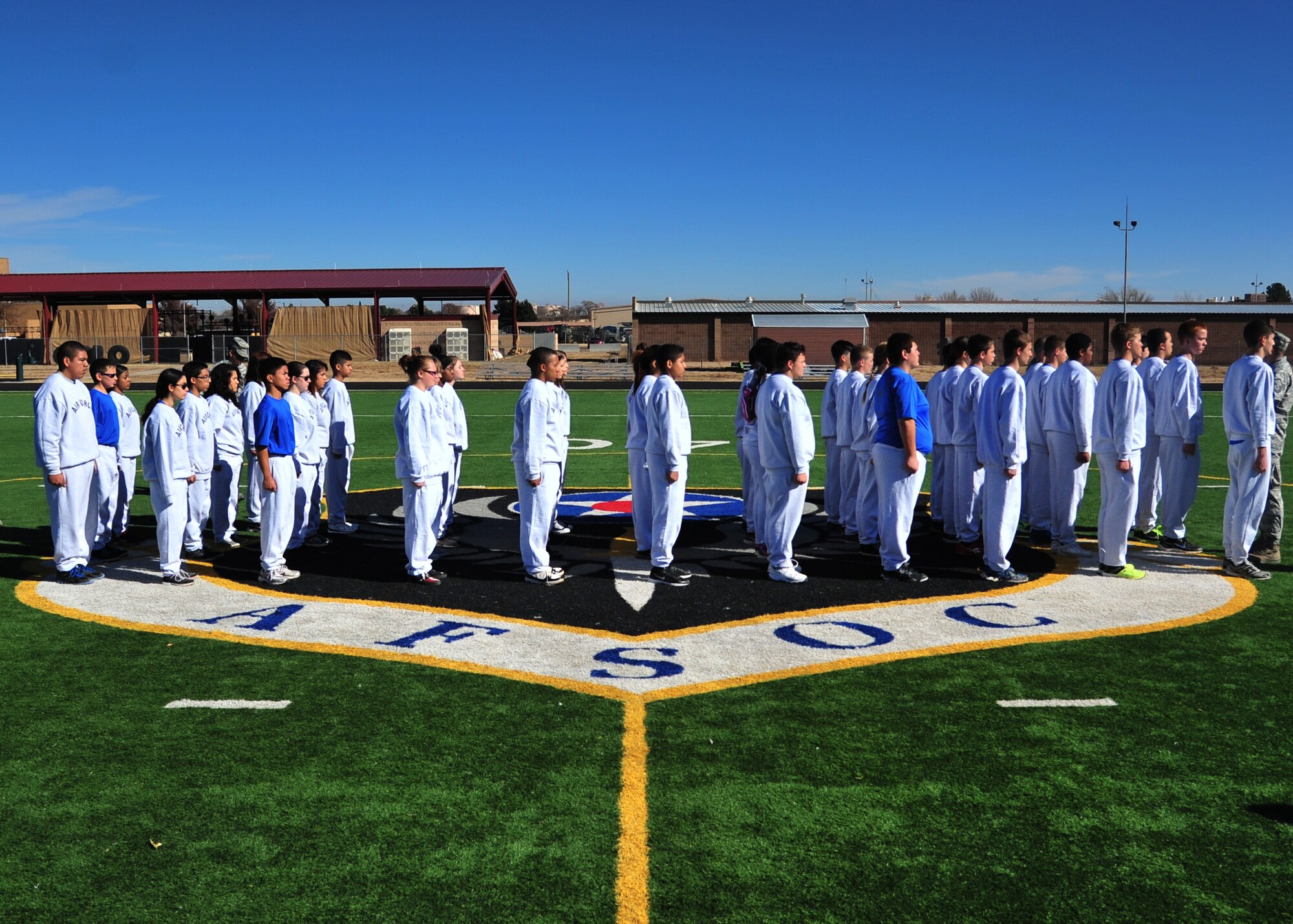 Clovis, New Mexico High School Junior Reserve Officer Training Corps cadets stand in formation at attention Nov. 21, 2014 at Cannon Air Force Base, N.M. Air Commandos rallied to provide the most realistic training experience for local cadets. (U.S. Air Force photo/Staff Sgt. Alexxis Mercer)