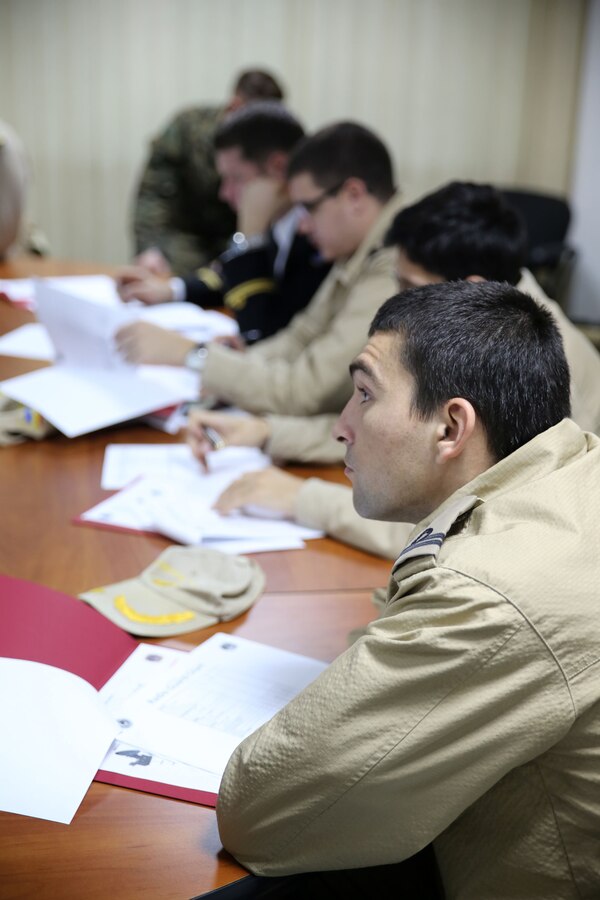 A Romanian soldier listens intently to Marines holding a class on data systems during a communications military-to-military exercise. Communications Marines from Black Sea Rotational Force held a two-day training exercise Nov. 12-13 in Constanta, Romania with members of the Romanian Armed Forces to discuss communication tactics, techniques, and procedures.