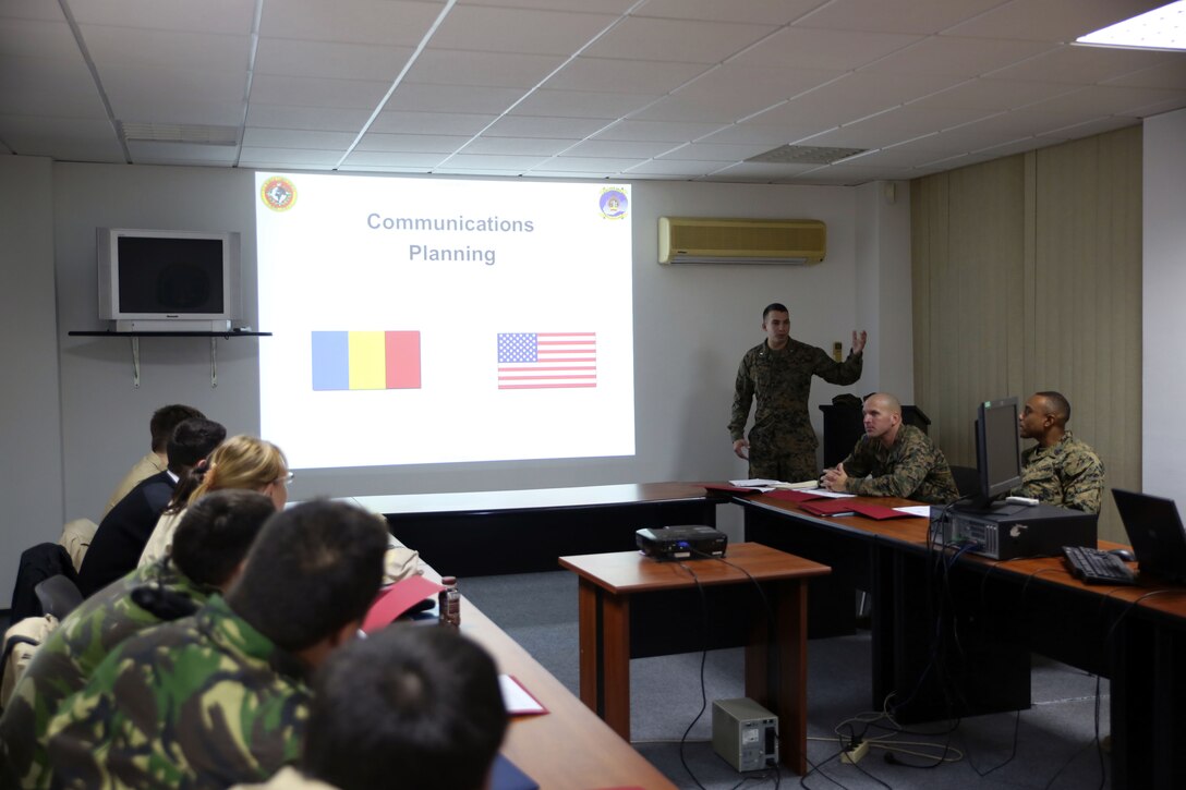 1st Lt. Julian D’orsaneo (rear center) begins his class on in-depth communications planning. Communications Marines from Black Sea Rotational Force held a two-day military-to-military training exercise Nov. 12-13 in Constanta, Romania with members of the Romanian Armed Forces to discuss communication tactics, techniques, and procedures.