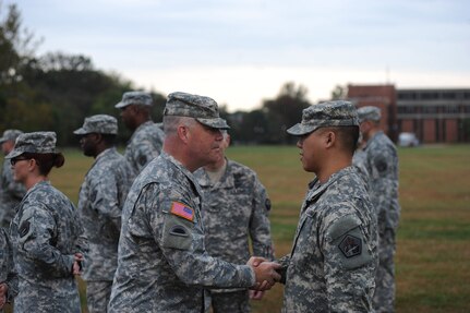 Army Maj. Gen. Judd H. Lyons, left, acting director of the Army National Guard, speaks with a member of the 1636th Cyber Protection Team during a patch ceremony at Fort George G. Meade, Maryland, Tuesday Oct. 7, 2014, where unit members received their shoulder sleeve insignia. The 1636th CPT is the first Army National Guard cyber protection team to be activated and several of its members recently graduated from the Cyber Network Defender Course, with several being named as honor graduates. 