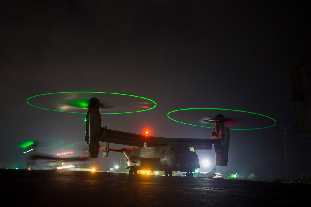 U.S. Marine Corps MV-22B Ospreys with SPMAGTF - Crisis Response - Africa prepare to fly at night as part of required training standards in order for pilots to continue to be qualified to carry passengers at night. while in support of Operation United Assistance in Monrovia, Liberia, Nov. 16, 2014. United Assistance is a Department of Defense operation to provide command and control, logistics, training and engineering support to U.S. Agency for International Development- led efforts to contain the Ebola virus outbreak in West African nations. (U.S. Marine Corps photo by Lance Cpl. Andre Dakis/SP-MAGTF Crisis Response Africa Combat Camera/Released)