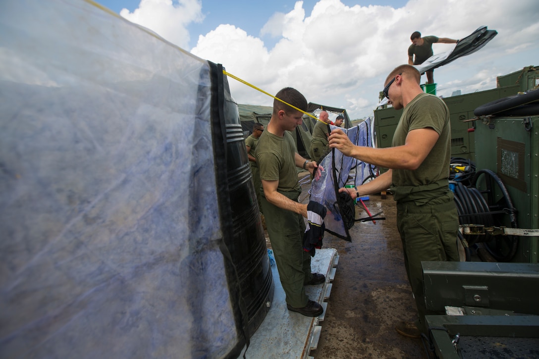 U.S. Marines with SPMAGTF - Crisis Response - Africa clean equipment in accordance with Centers for Disease Control and Prevention cleaning and decontamination guidelines, as part of the standard procedure of washing gear prior to leaving the country, while in support of Operation United Assistance in Monrovia, Liberia, Nov. 19, 2014. United Assistance is a Department of Defense operation to provide command and control, logistics, training and engineering support to U.S. Agency for International Development- led efforts to contain the Ebola virus outbreak in West African nations. (U.S. Marine Corps photo by Lance Cpl. Andre Dakis/SP-MAGTF Crisis Response Africa Combat Camera/Released)