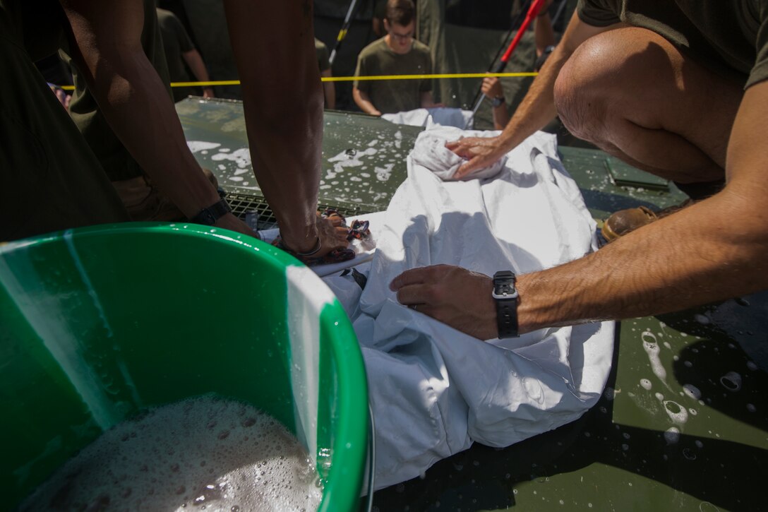 U.S. Marines with SPMAGTF - Crisis Response - Africa clean equipment in accordance with Centers for Disease Control and Prevention cleaning and decontamination guidelines, as part of the standard procedure of washing gear prior to leaving the country, while in support of Operation United Assistance in Monrovia, Liberia, Nov. 19, 2014. United Assistance is a Department of Defense operation to provide command and control, logistics, training and engineering support to U.S. Agency for International Development- led efforts to contain the Ebola virus outbreak in West African nations. (U.S. Marine Corps photo by Lance Cpl. Andre
Dakis/SP-MAGTF Crisis Response Africa Combat Camera/Released)