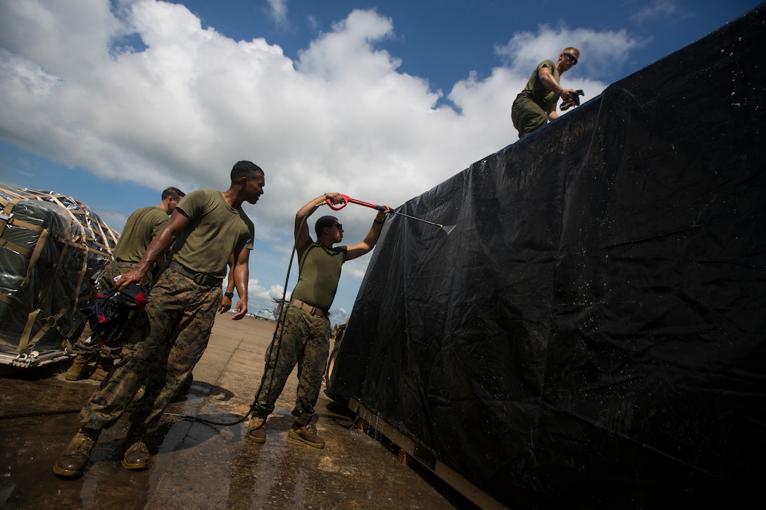 U.S. Marines with SPMAGTF - Crisis Response - Africa clean equipment in accordance with Centers for Disease Control and Prevention cleaning and decontamination guidelines, as part of the standard procedure of washing gear prior to leaving the country, while in support of Operation United Assistance in Monrovia, Liberia, Nov. 19, 2014. United Assistance is a Department of Defense operation to provide command and control, logistics, training and engineering support to U.S. Agency for International Development- led efforts to contain the Ebola virus outbreak in West African nations. (U.S. Marine Corps photo by Lance Cpl. Andre Dakis/SP-MAGTF Crisis Response Africa Combat Camera/Released)