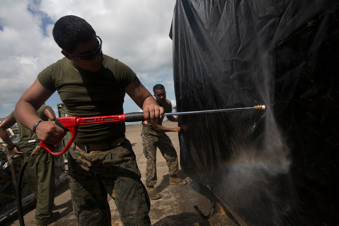 U.S. Marine Corps Cpl. Ian Delacruz, assigned to SPMAGTF - Crisis Response – Africa, cleans equipment in accordance with Centers for Disease Control and Prevention cleaning and decontamination guidelines, as part of the standard procedure of washing gear prior to leaving the country, while in support of Operation United Assistance in Monrovia, Liberia, Nov. 19, 2014. United Assistance is a Department of Defense operation to provide command and control, logistics, training and engineering support to U.S. Agency for International Development- led efforts to contain the Ebola virus outbreak in West African nations. (U.S. Marine Corps photo by Lance Cpl. Andre Dakis/SP-MAGTF Crisis Response Africa Combat Camera/Released)