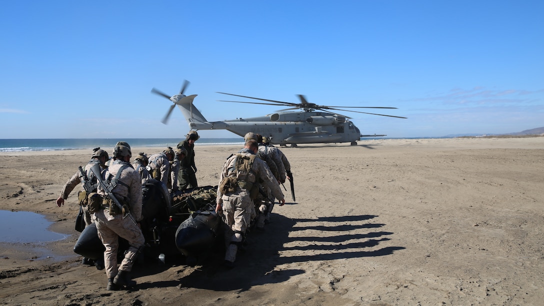 Marines with 2nd Platoon, Force Company, 1st Reconnaissance Battalion, I Marine Expeditionary Force, load a combat rubber raiding craft for helocast operations off the coast of Marine Corps Base Camp Pendleton, Calif., Nov. 19, 2014. Helocast operations allow recon Marines to move from air to land in a quick and stealthy manner.