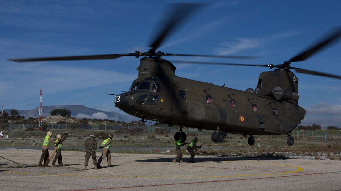 U.S. Marines with SPMAGTF Crisis Response - Africa and Spanish soldiers with Transport Helicopter Battalion 5, prepare to sling two water bladders to the bottom of the Spanish Army CH-47 Chinook, at Colmenar de Viejo, Spain, Nov. 18, 2014. The 4,300 pound water bladders can be used to transport clean water to support troops operating in a location without potable water or when conducting humanitarian assistance missions. The training enhanced mission readiness and help build relationships between the two militaries. (U.S. Marine Corps photo by Cpl Jeraco Jenkins/Released).