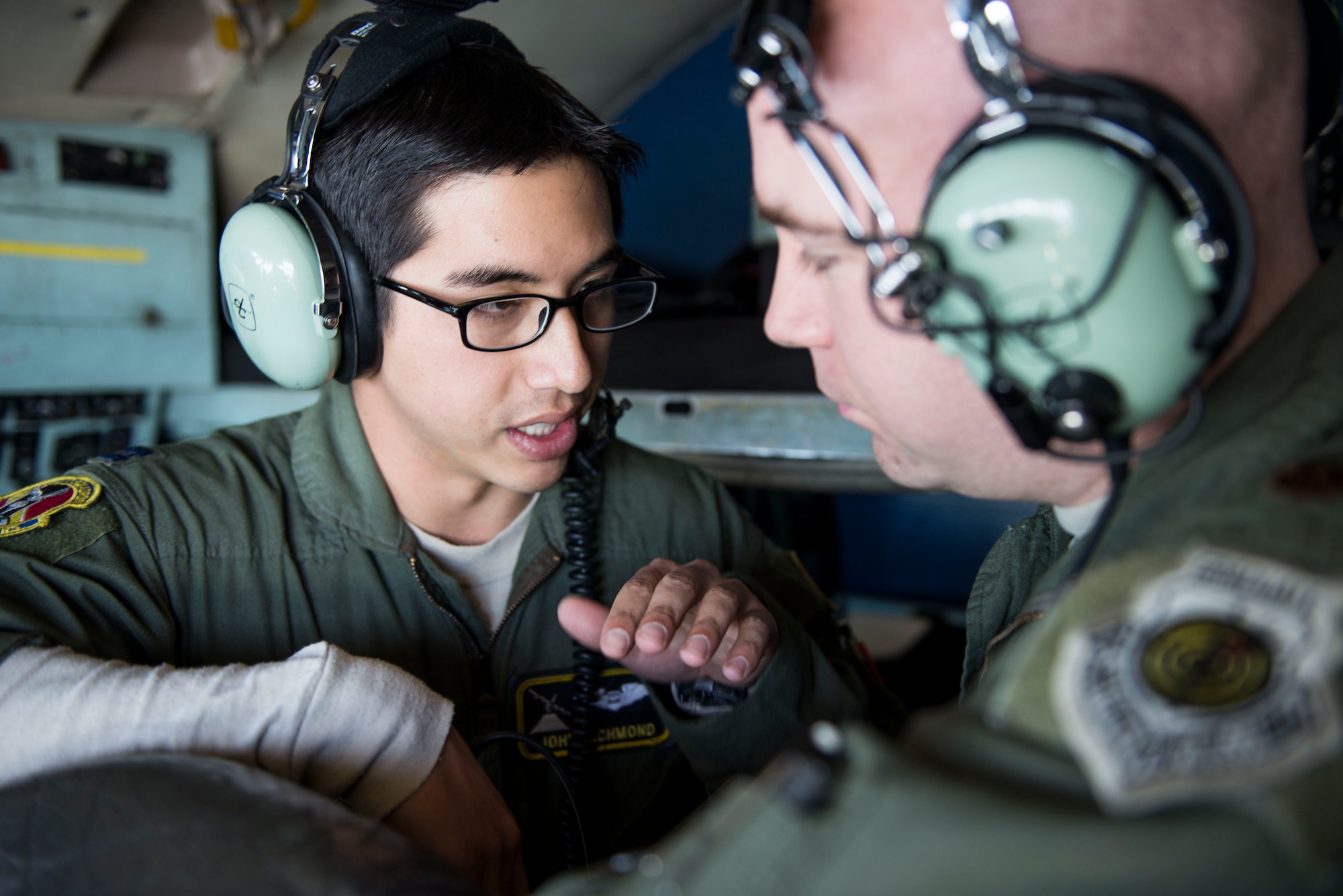 Capt. John Richmond communicates with Maj. Andrew Baker during Exercise Max Thunder Nov. 19, 2014, over South Korea. Richmond ensured his flight maintained their planned course during the exercise. Richmond is a 36th Airlift Squadron C-130 Hercules navigator and Baker is a 36th AS weapons and tactics flight commander. (U.S. Air Force photo/Staff Sgt. Cody H. Ramirez)