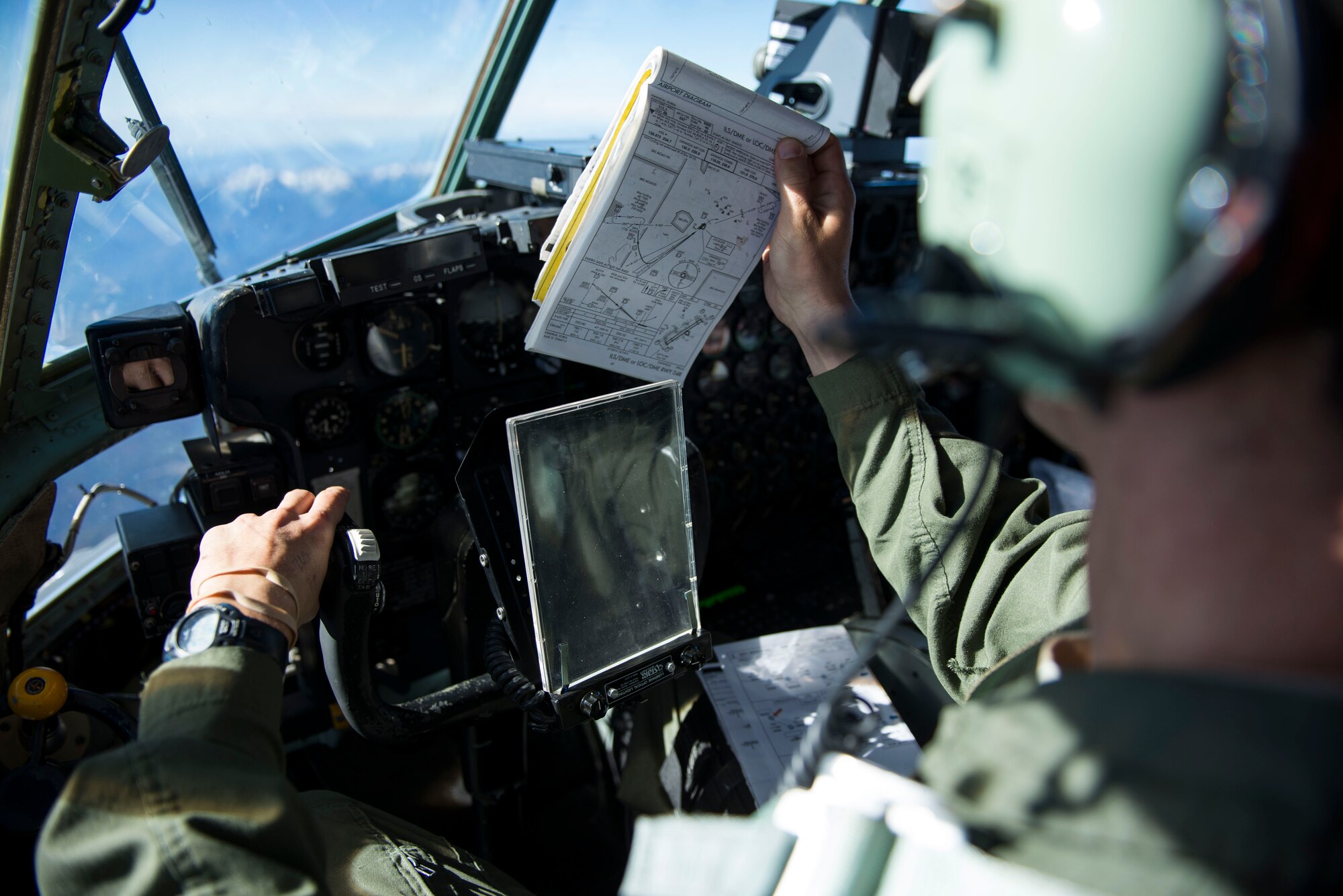 Capt. Shawn Hooton puts a map on display during a flight Nov. 19, 2014, over South Korea. Hooton and other members of the 36th Airlift Squadron flew to South Korea to participate in Max Thunder, a biannual exercise focused on improving the interoperability of the U.S.-South Korea partnership. Hooton is a 36th AS C-130 Hercules pilot. (U.S. Air Force photo/Staff Sgt. Cody H. Ramirez)
