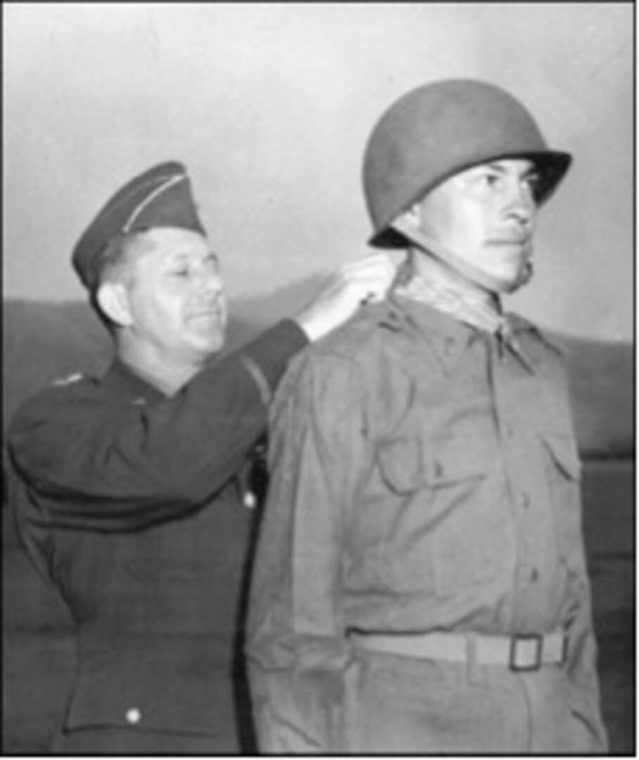 Lt. Gen. Jacob Devers awards the Medal of Honor to 2nd Lt. Ernest L. Childers, April 8, 1944.