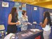 Rose Day, left, and Julia Ignacek, center, answer questions from an attendee of the 41st Annual National Organization for the Professional Advancement of Black Chemists and Chemical Engineers Conference  Sept. 23, 2014, in New Orleans. Day and Ignacek are members of the Air Force Technical Applications Center at Patrick AFB, Fla. The co-workers set up a booth to reach out to a diverse audience of scientists, educators, managers, engineers and students who attended the week-long event. (Courtesy photo)