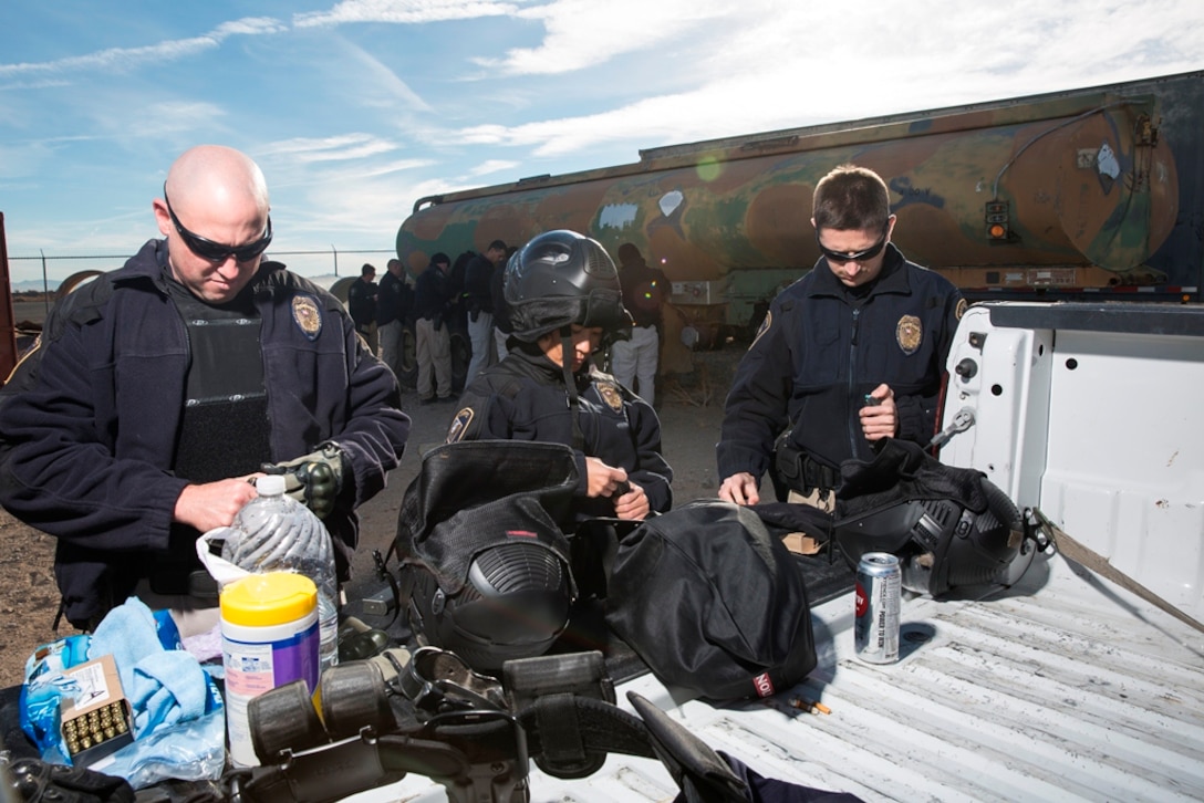 Officers from Marine Corps Logistics Base Barstow, Calif. police department prepare for an active shooter training exercise at the MCLBB Security and Emergency Services training facility on November 18.  The exercise used simulated ammunition in order to allow participants to use their duty weapon while combating opposing force personnel.
