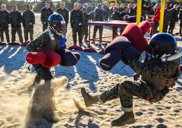 A recruit of Charlie Company, 1st Recruit Training Battalion, knocks his opponent down during a pugil stick bout at Marine Corps Recruit Depot San Diego, Nov. 5. Recruits were told to play the role of offense or defense, and were given three 30-second bouts using the techniques they learned throughout their classes and events to give the opponent a striking blow to head.