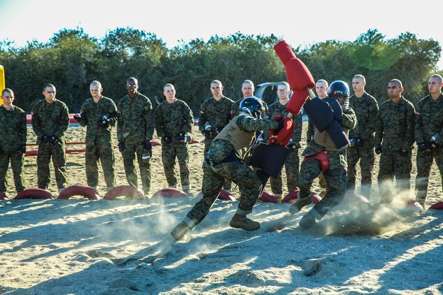 A recruit of Charlie Company, 1st Recruit Training Battalion, knocks his opponent down during a pugil stick bout at Marine Corps Recruit Depot San Diego, Nov. 5. Recruits were told to play the role of offense or defense, and were given three 30-second bouts using the techniques they learned throughout their classes and events to give the opponent a striking blow to head.