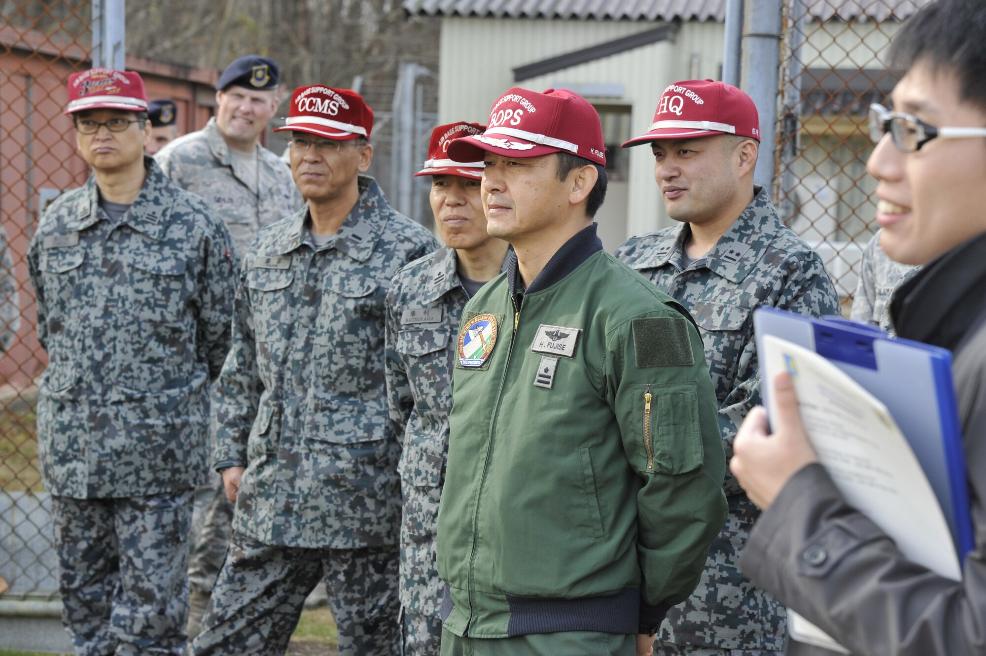 Japan Air Self Defense Force Maj. Hirotaka Fujise (center) observes a live demonstration by the military working dog handlers from 35th Security Forces Squadron at Misawa Air Base, Japan, Nov. 25, 2014. JASDF officers stopped by the MWD’s kennel to observe how the 35 SFS works with their canine partners. (U.S. Air Force photo by Airman 1st Class Patrick S. Ciccarone/Released)