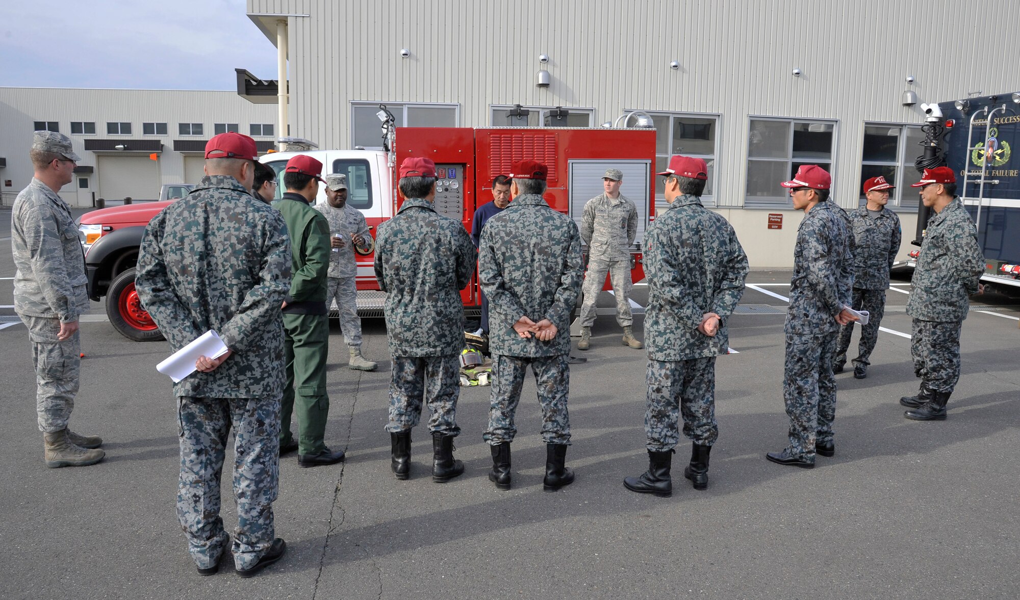 Members of the 35th Civil Engineer Squadron fire department showcase equipment to Japan Air Self-Defense Force officers at Misawa Air Base, Japan, Nov. 25, 2014. JASDF took part in a morning of demonstrations and briefings hosted by various 35 CES agencies to familiarize them on their squadron’s mission. (U.S. Air Force photo by Airman 1st Class Patrick S. Ciccarone/Released)