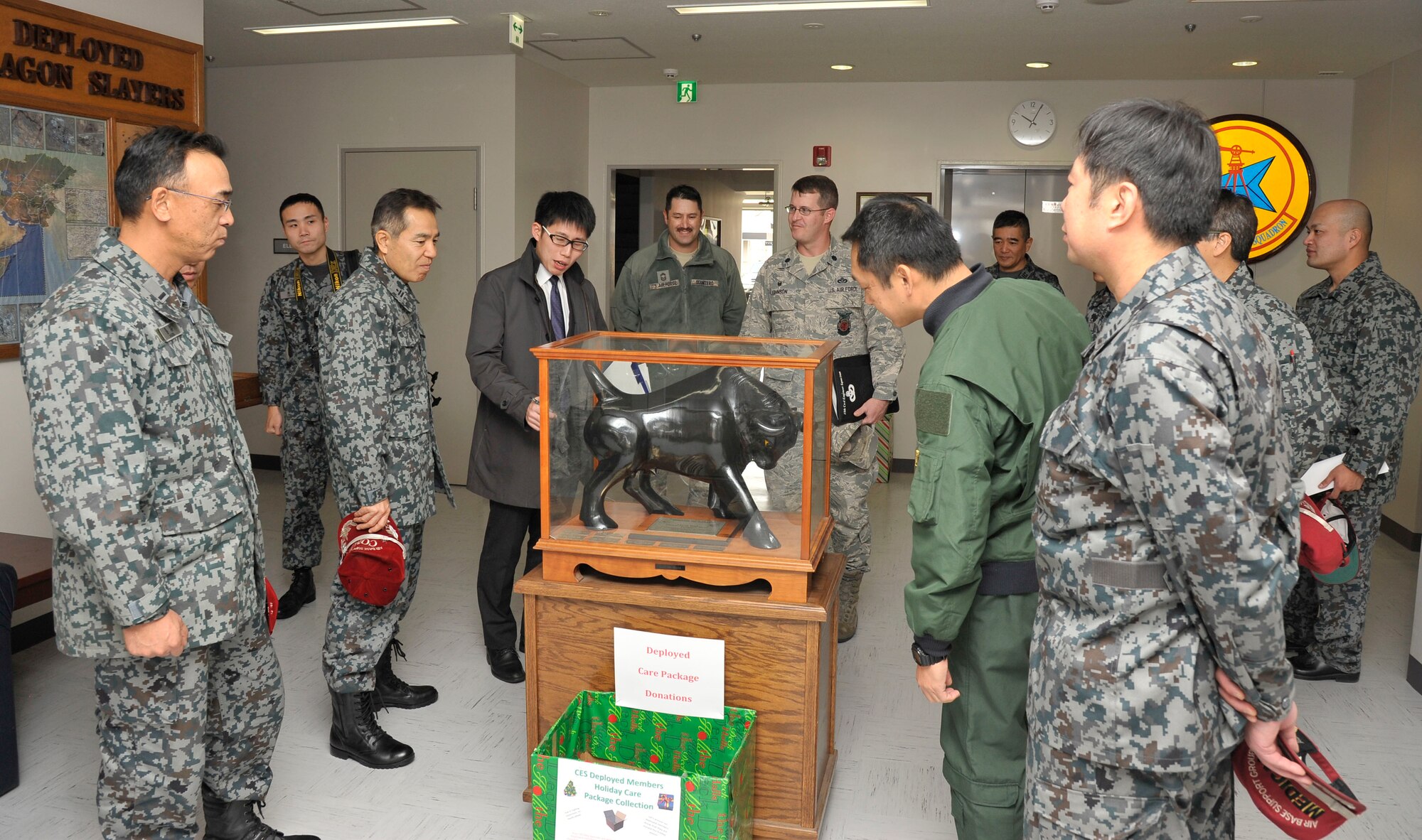 Japanese Air Self Defense Force officers become acquainted with the history of the 35th Civil Engineer Squadron at Misawa Air Base, Japan, Nov. 25, 2014. During their visit to the 35 CES, JASDF members were familiarized with equipment from the squadron’s Fire Department, Explosive Ordnance Disposal and construction teams. (U.S. Air Force photo by Airman 1st Class Patrick S. Ciccarone/Released)